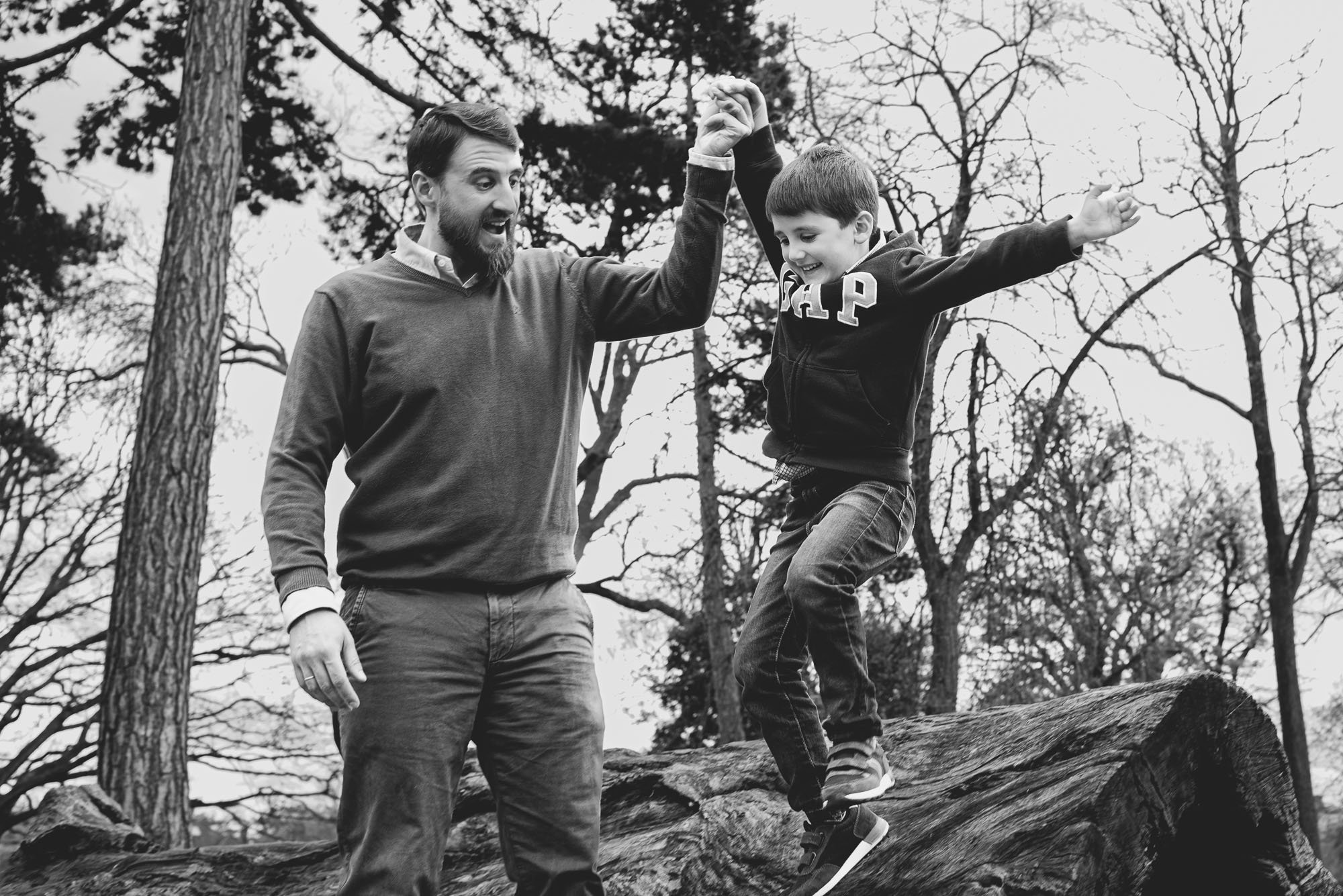 dad-son-walking-tree-trunk-park-natural-candid-children-photography-east-dulwich-peckham-rue-park-black-and-white-family-portrait.jpg