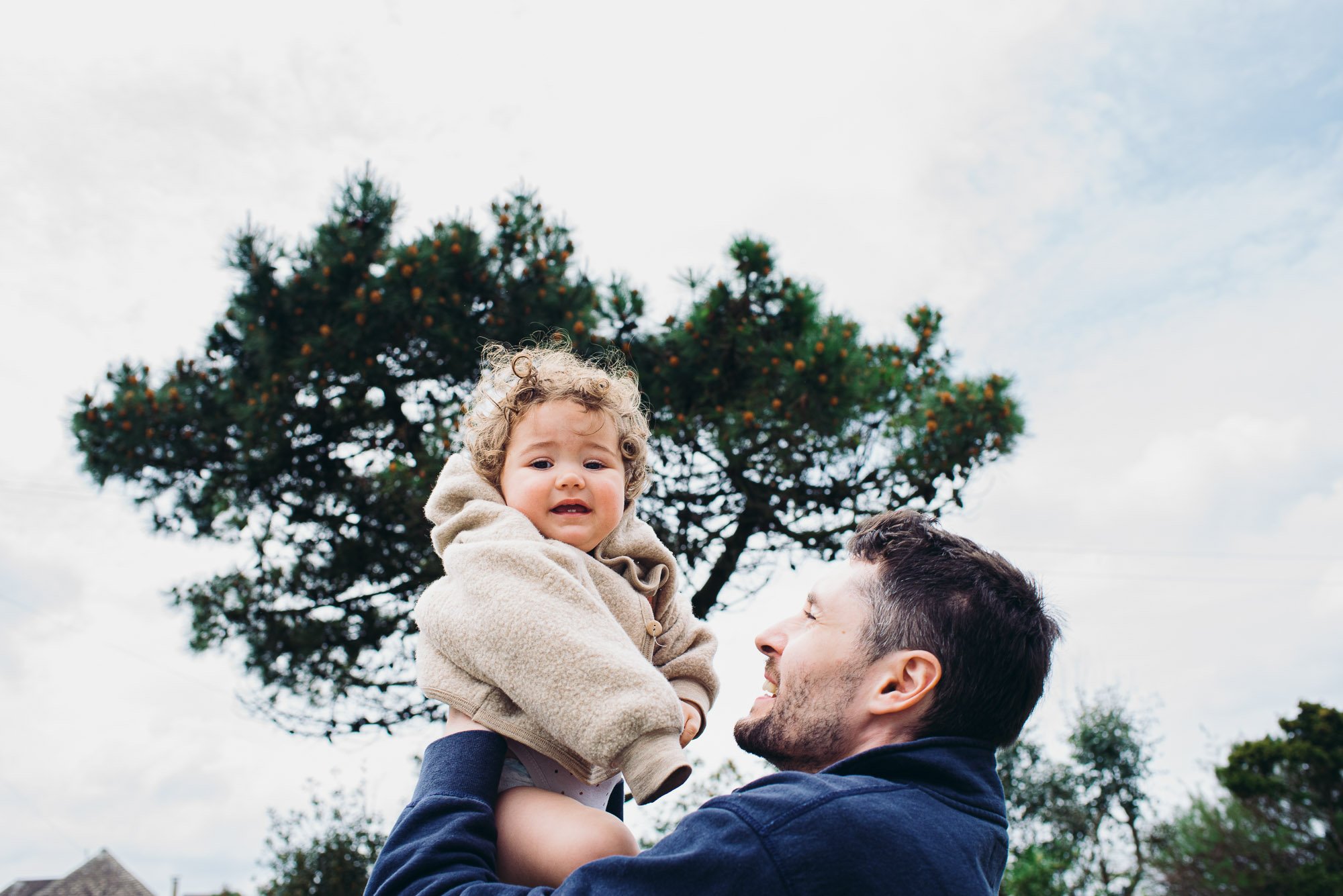 dad-daughter-portrait-outdoors-west-wittering-beach-west-sussex-family-photography-tree-in-background.jpg