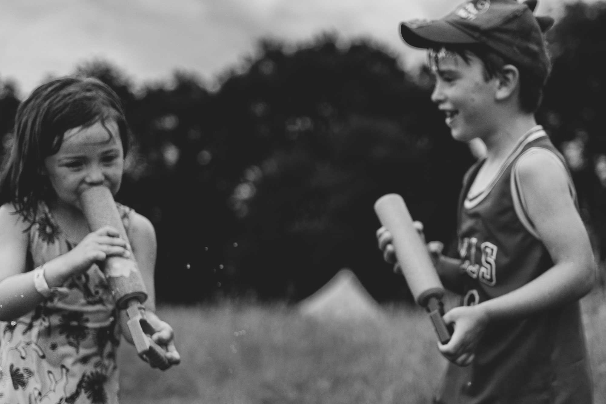 boy-and-girl-water-guns-summer-sussex-family-photographer-black-and-white-family-portrait.jpg