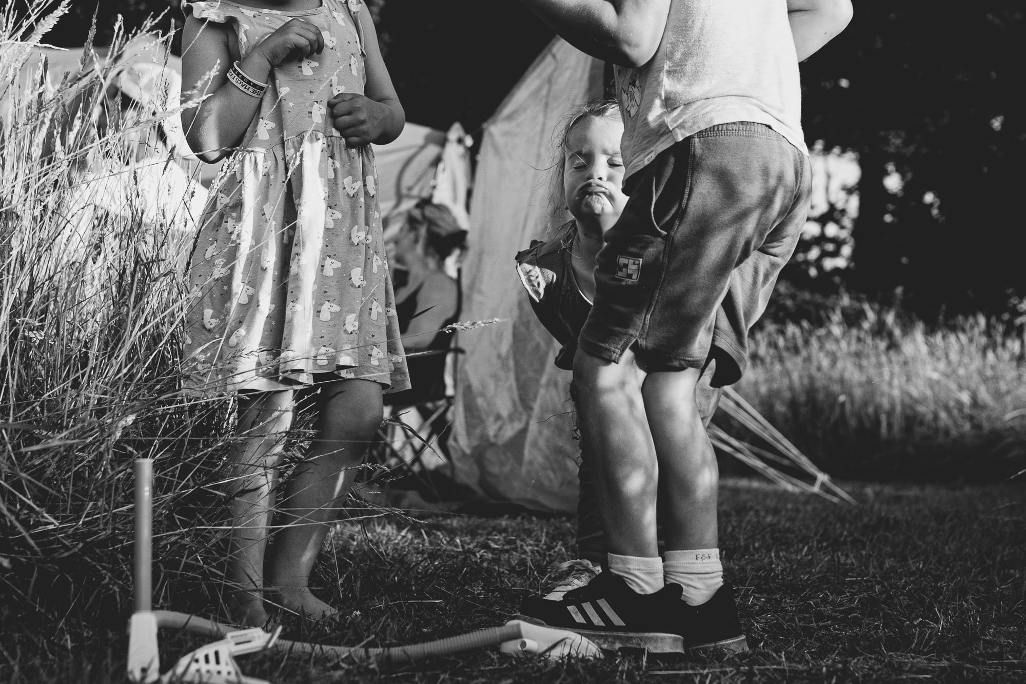 girl-playing-outdoors-rocket-camping-family-unposed-photography-ditchling-sussex-family-photographer.jpg
