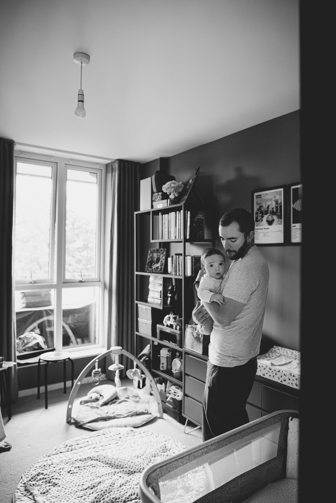 dad-newborn-baby-at-home-nursery-natural-newborn-baby-photographer-london-black-and-white.jpg
