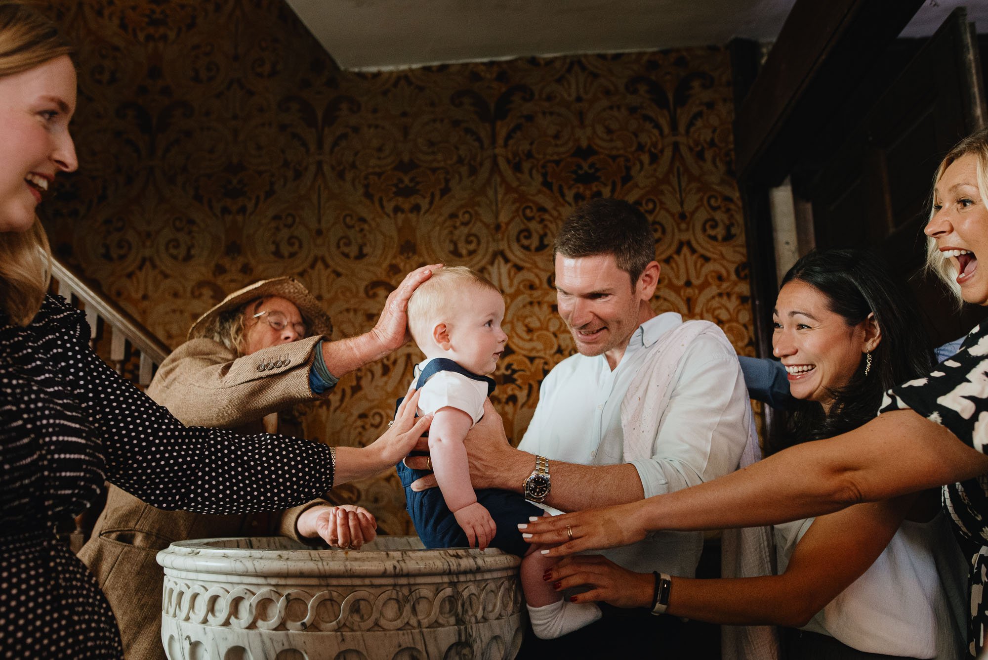 boy-getting-christened-holding-hands-sussex-christening-photography-unposed-natural.jpg