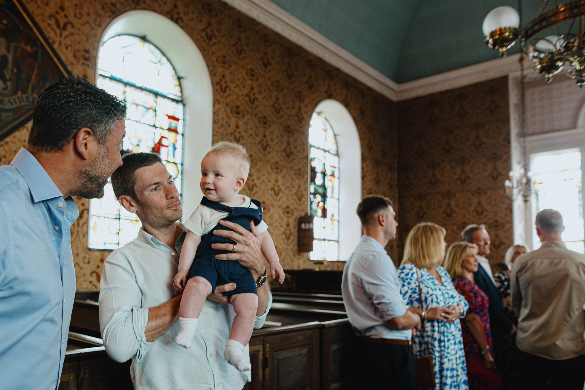 brighton-christening-photography-sussex-family-photographer-boy-held-by-dad-in-church-lewes.jpg