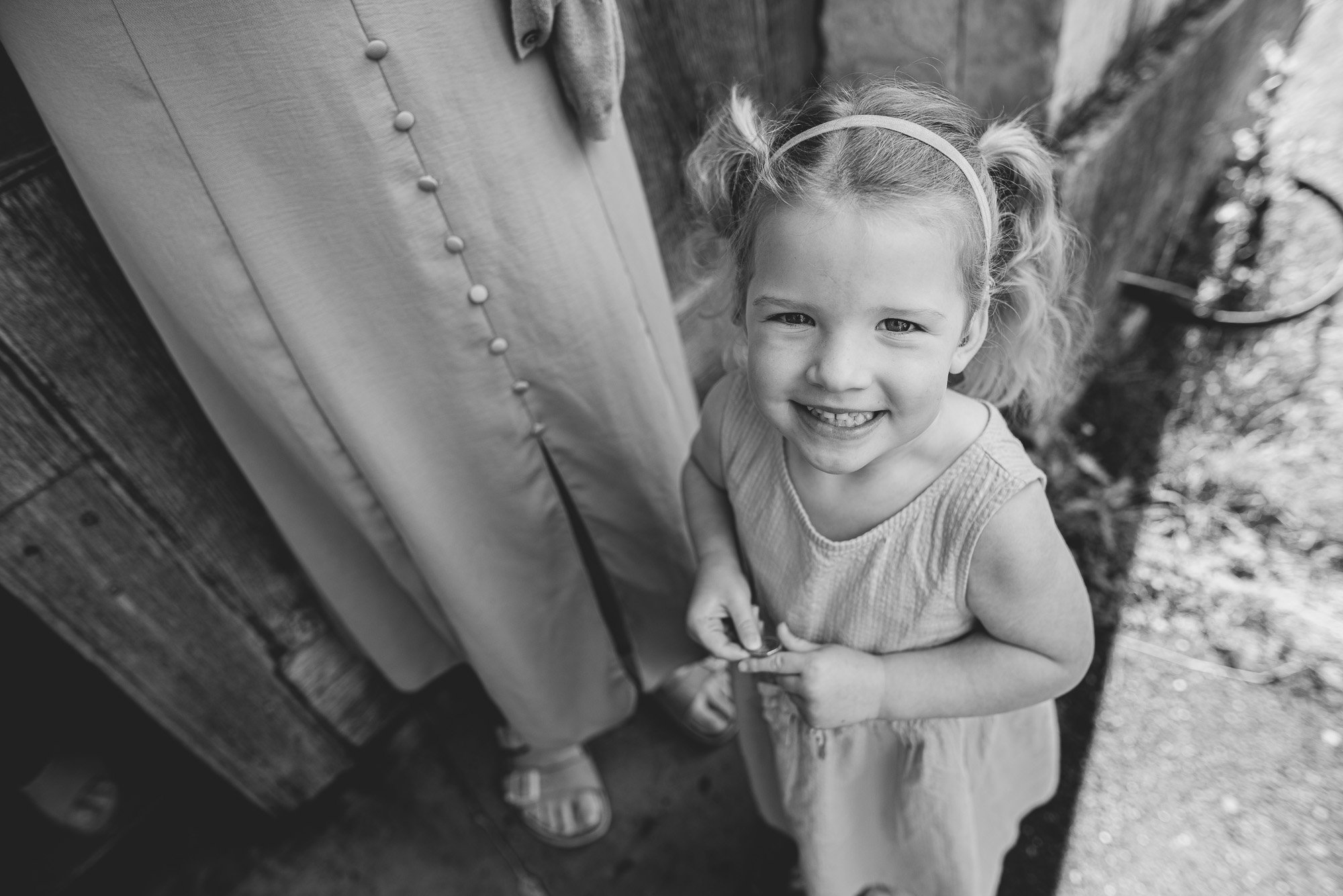 girl-standing-outside-church-during-christening-baby-boy-sussex-lewes-hove-worthing-brighton-informal-christening-photos.jpg
