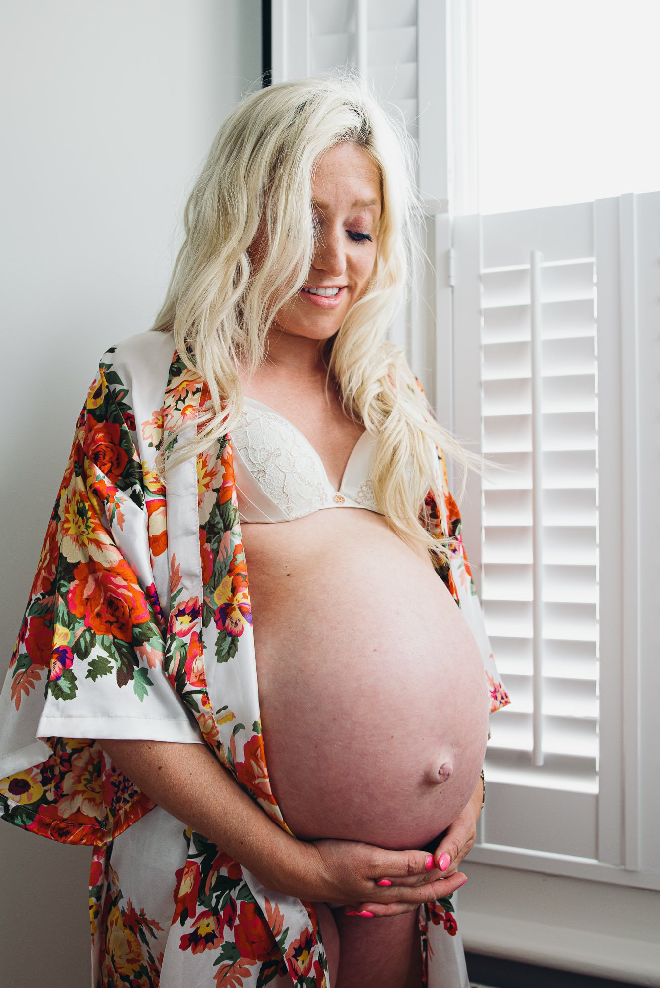 at-home-maternity-photographer-brighton-hove-sussex-worthing-lewes-woman-bedroom-window-pregnant-belly.jpg