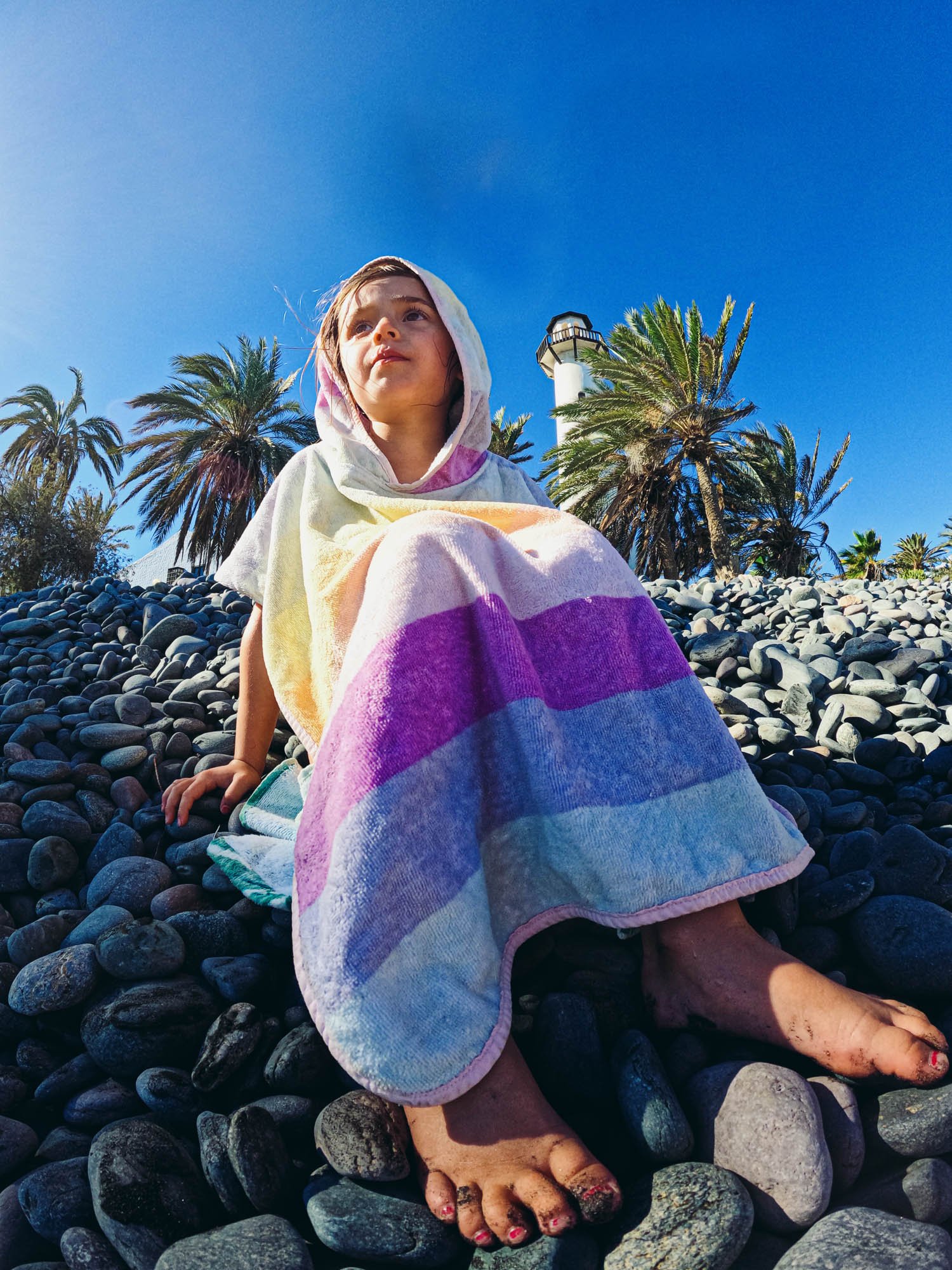 gopro-portrait-girl-pebbles-towel-beach-palmtrees-documentary-family-photos-holiday.jpg