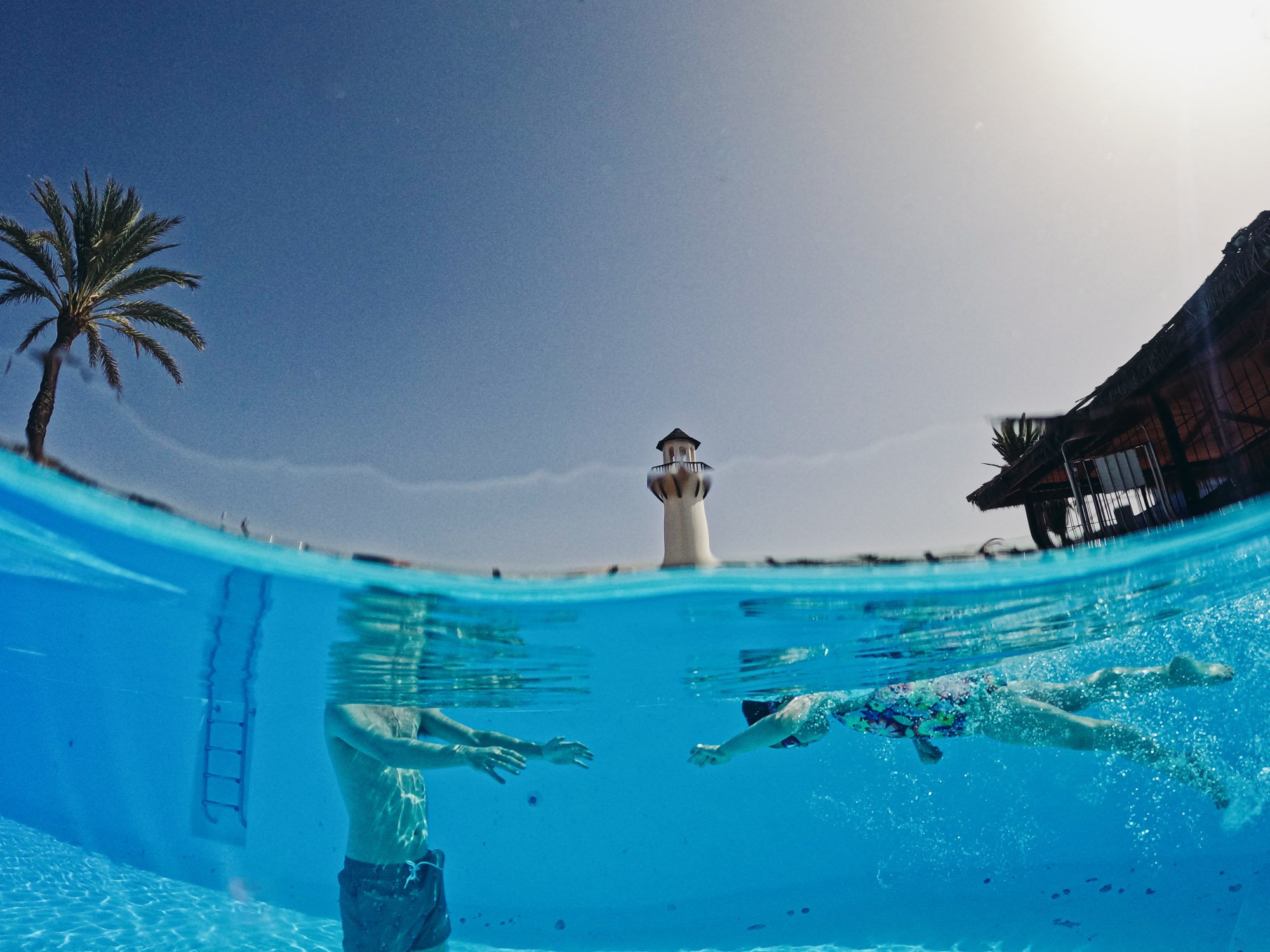 hal-underwater-shot-pool-girl-dad-swimming-unposed-family-photography-documentary-style-sussex-family-photographer.jpg