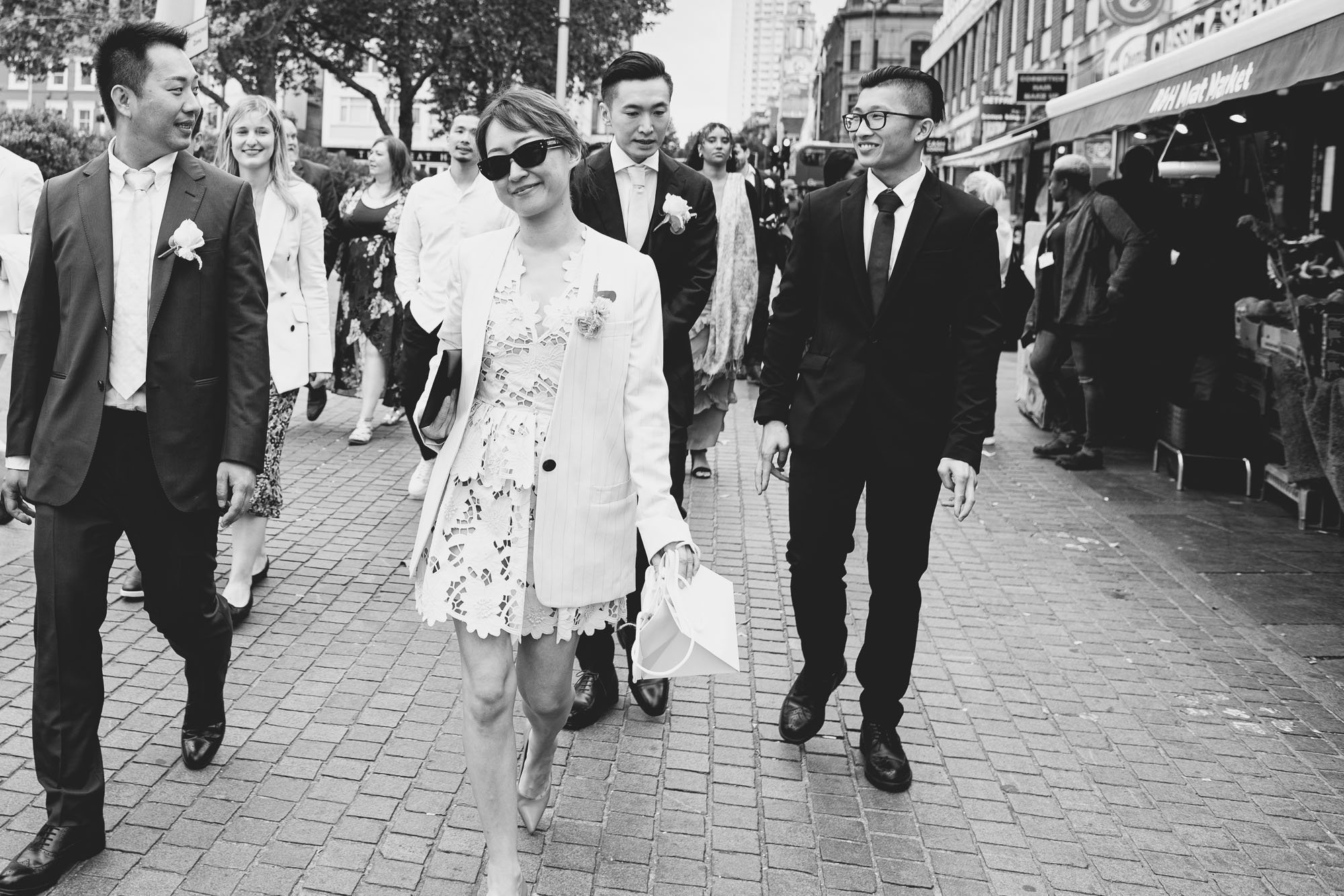 wedding-guests-greenwich-london-walking-to-venue-natural-wedding-photography-brighton-hove-reportage-style.jpg