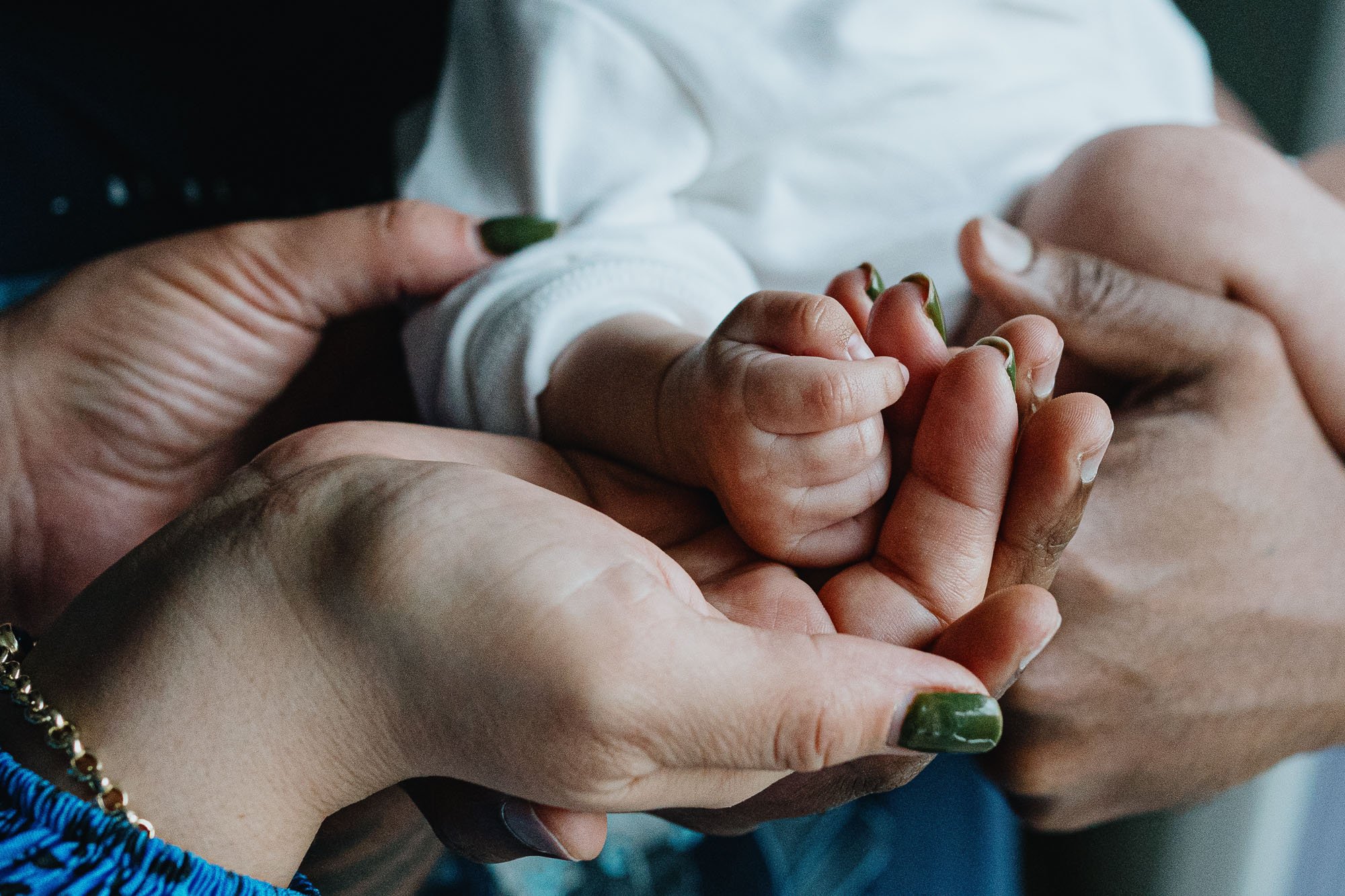 baby-hand-in-parents-hands-at-home-newborn-photo-session-brighton-hove-sussex.jpg