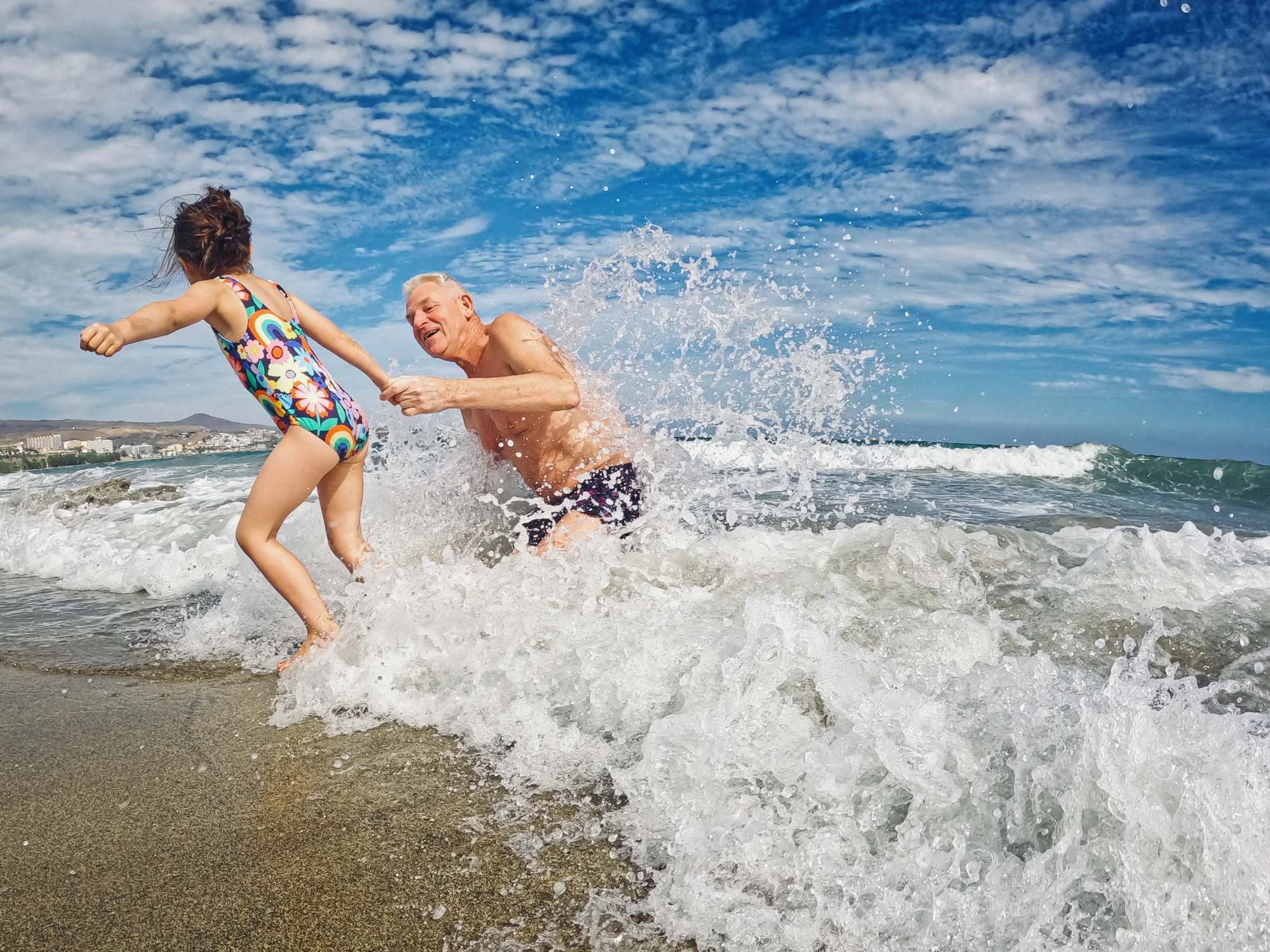 child-grandfather-playing-in-the-waves-sea-summer-beach-family-photos-unposed-family-photographer-brighton-hove-worthing-shoreham.jpg