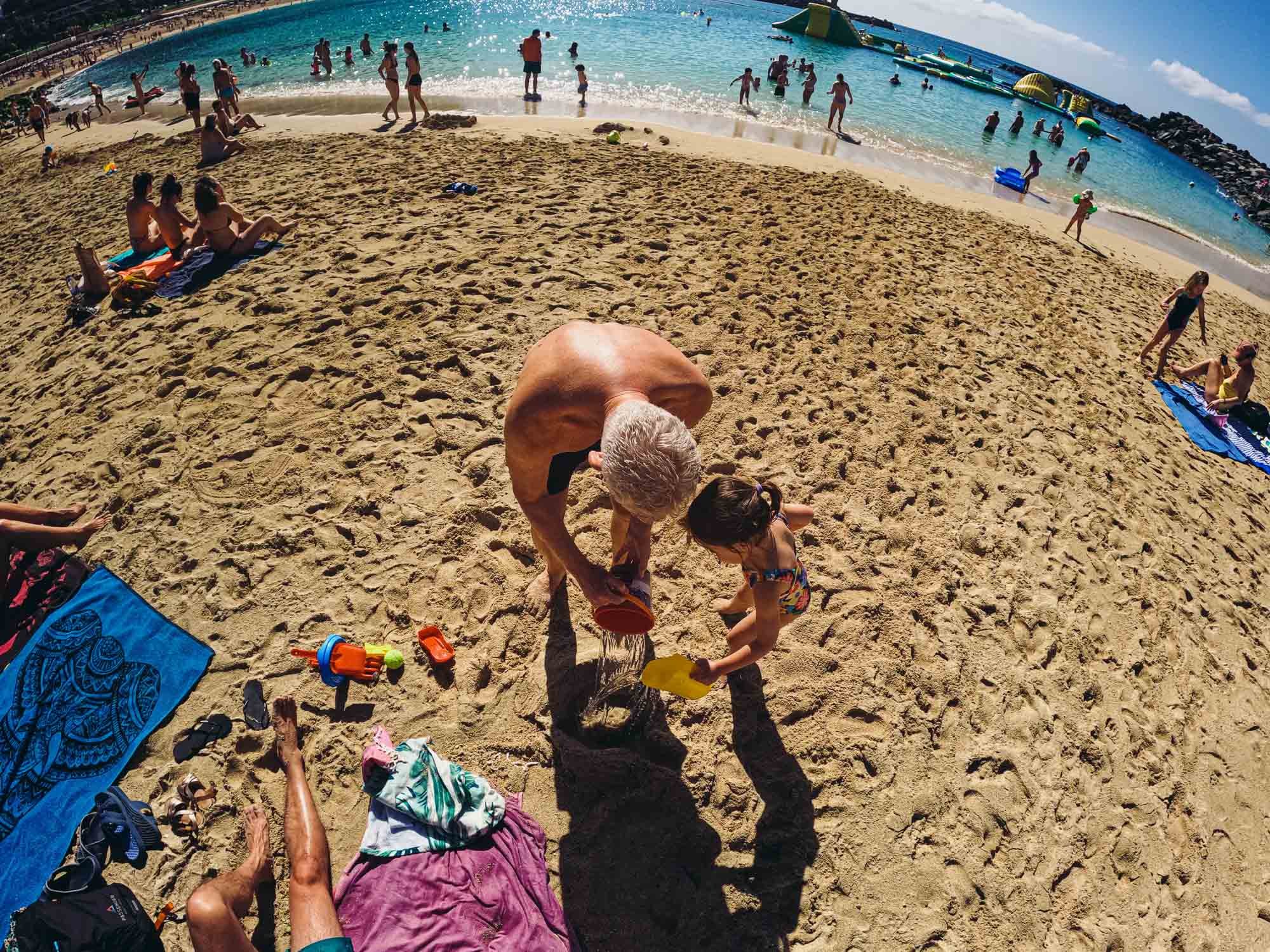 documentary-family-photography-girl-grandpa-beach-photo-shoot-summer-holiday-playing-with-sand.jpg