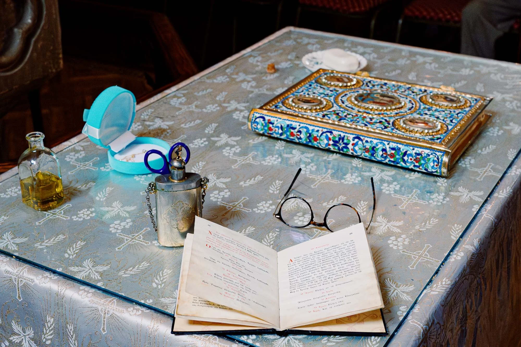 London Baptism photographer capturing Greek Orthodox ceremony, cutting baby's hair.
