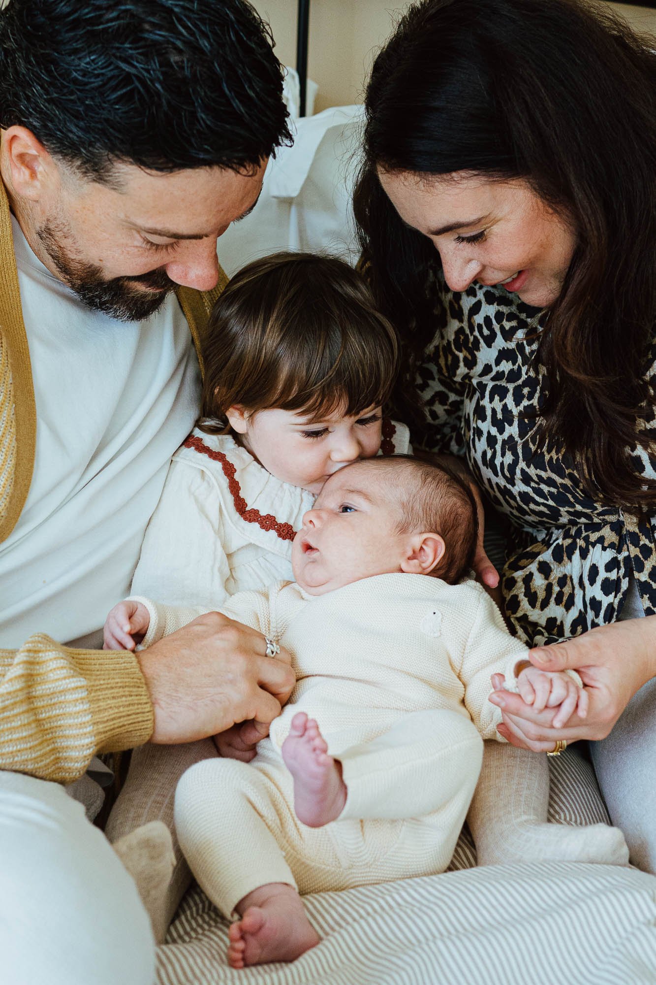 Putney newborn photographer capturing natural portrait of family of four taken at home in Putney.