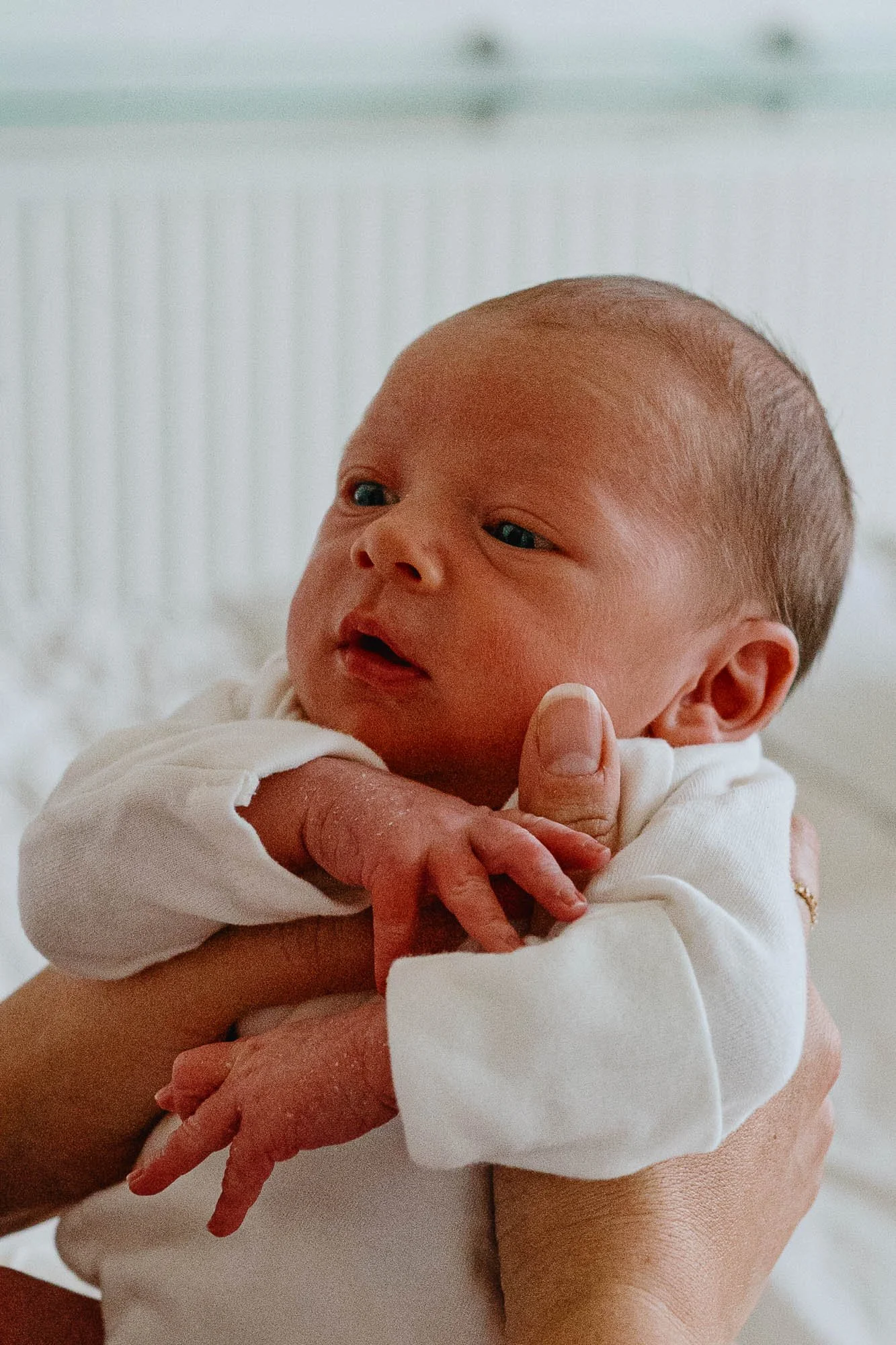 newborn-baby-boy-portrait-open-eyes-held-by-mum-at-home-clapham-newborn-photoshoot.jpg