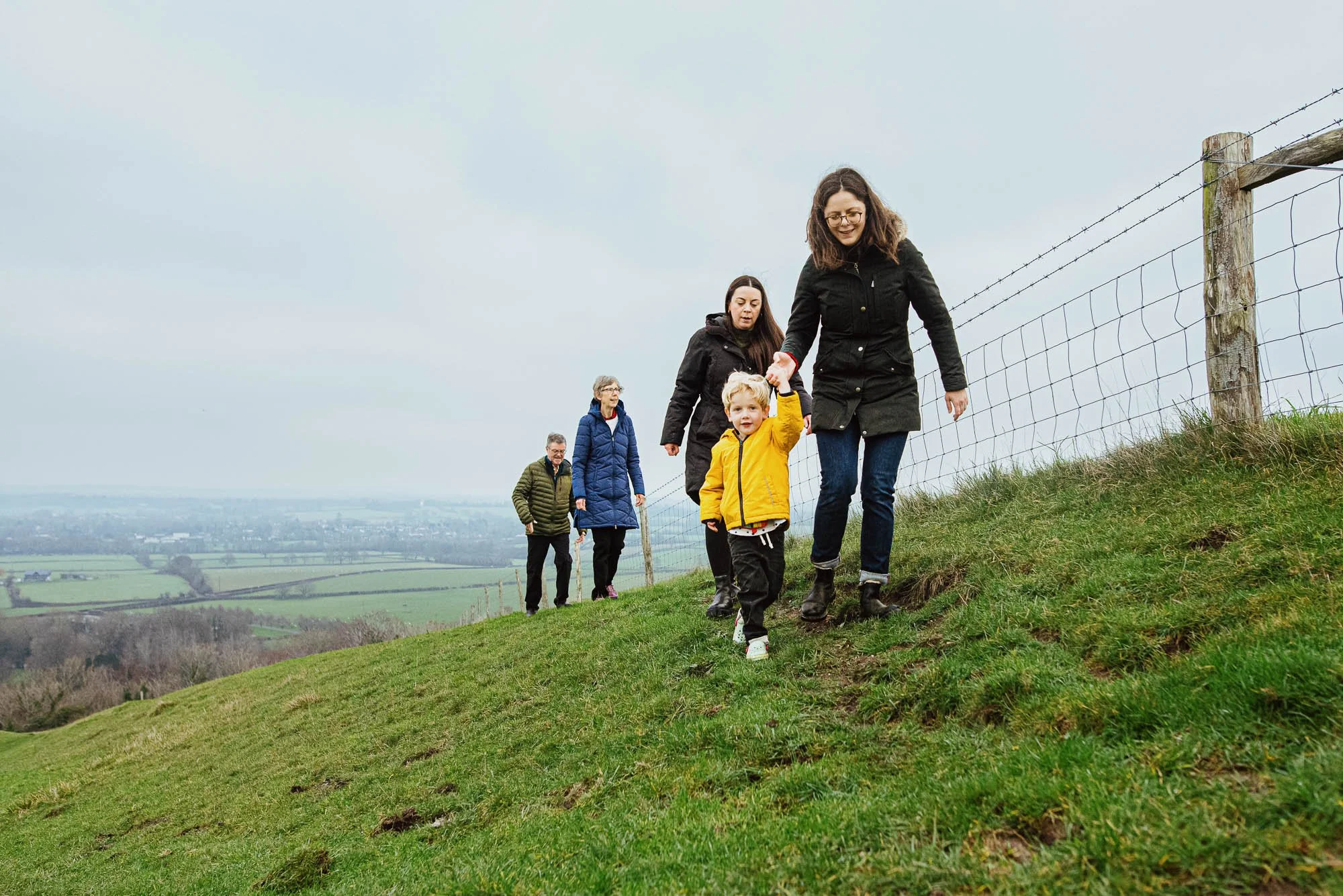 Chichester family photographer capturing family walk in the South Downs.