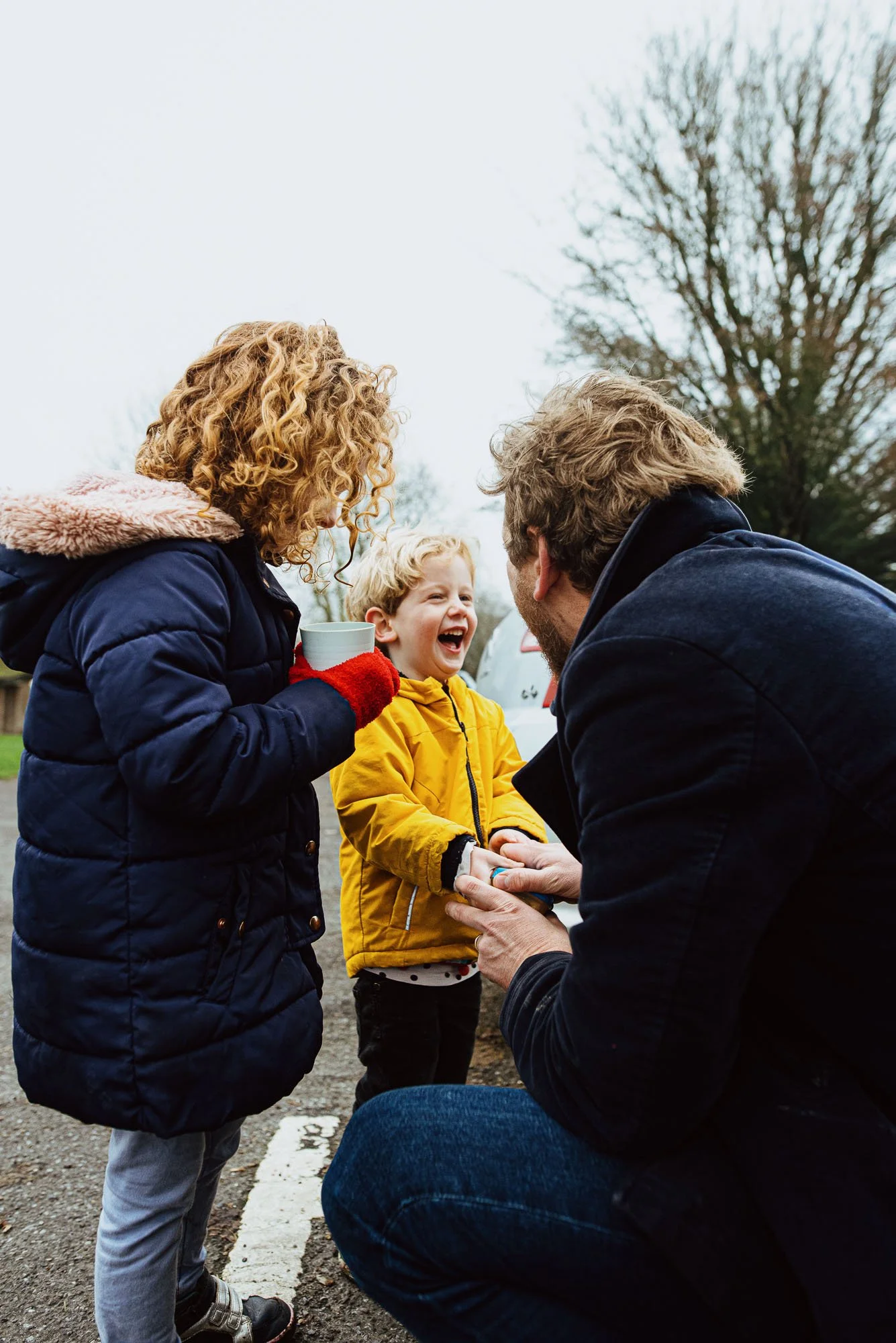 boy-laughing-drinking-hot-chocolatesister-sussex-winter-walk-family-photoshoot-burgess-hill-hassocks-horsham.jpg