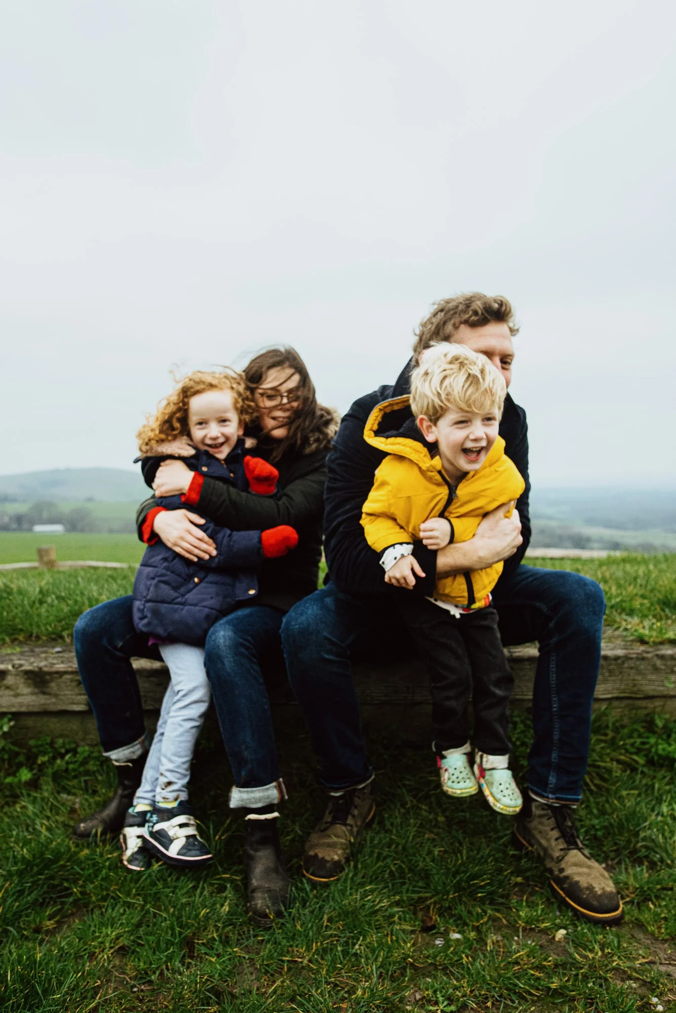 natural-family-portrait-parents-hugging-kids-hill-sussex-family-photoshoot-hassocks-butchers-wood.jpg