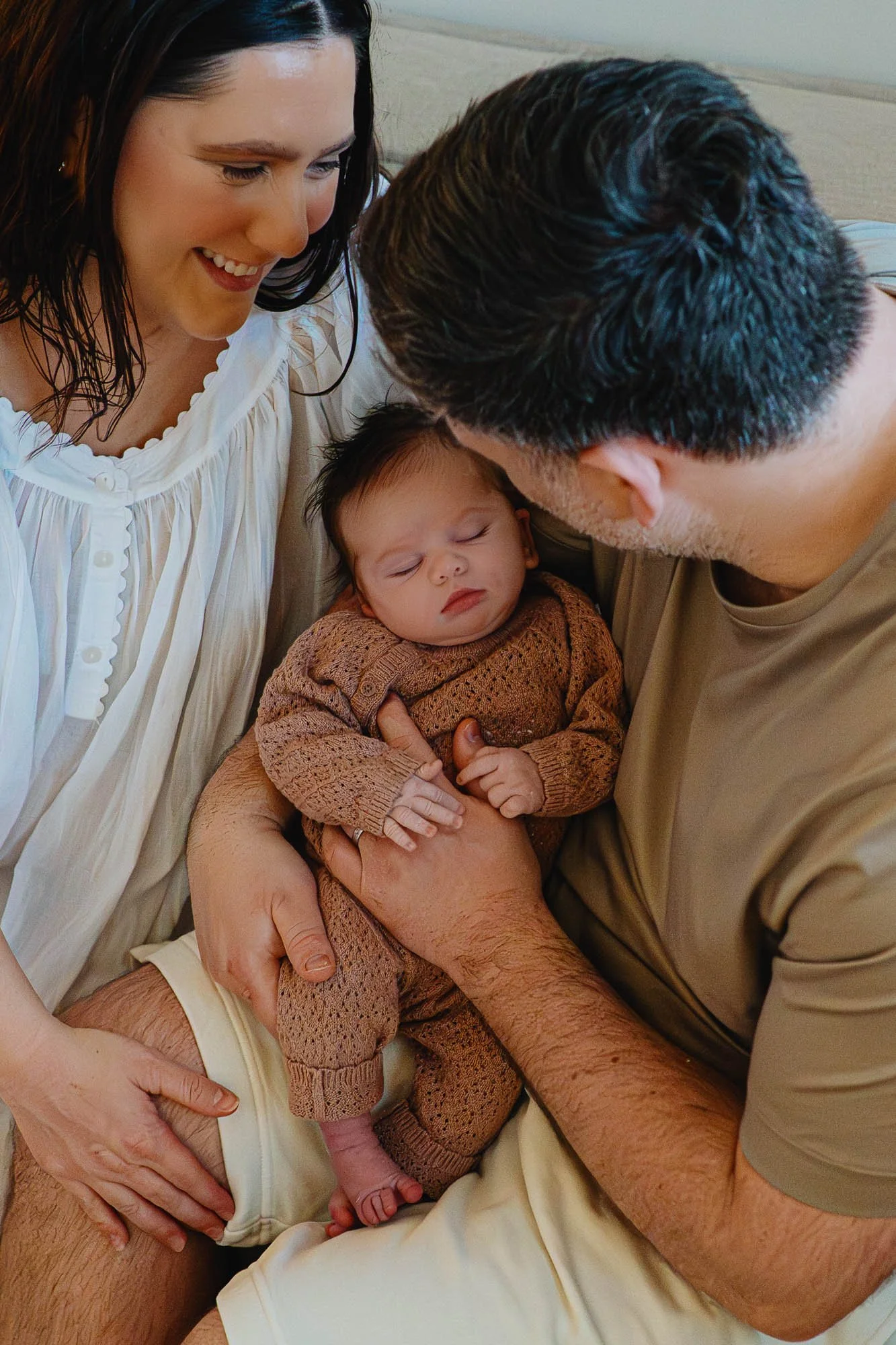 baby-girl-aslee-smiling-parents-at-home-newborn-photography-portslade-hove-sussex.jpg