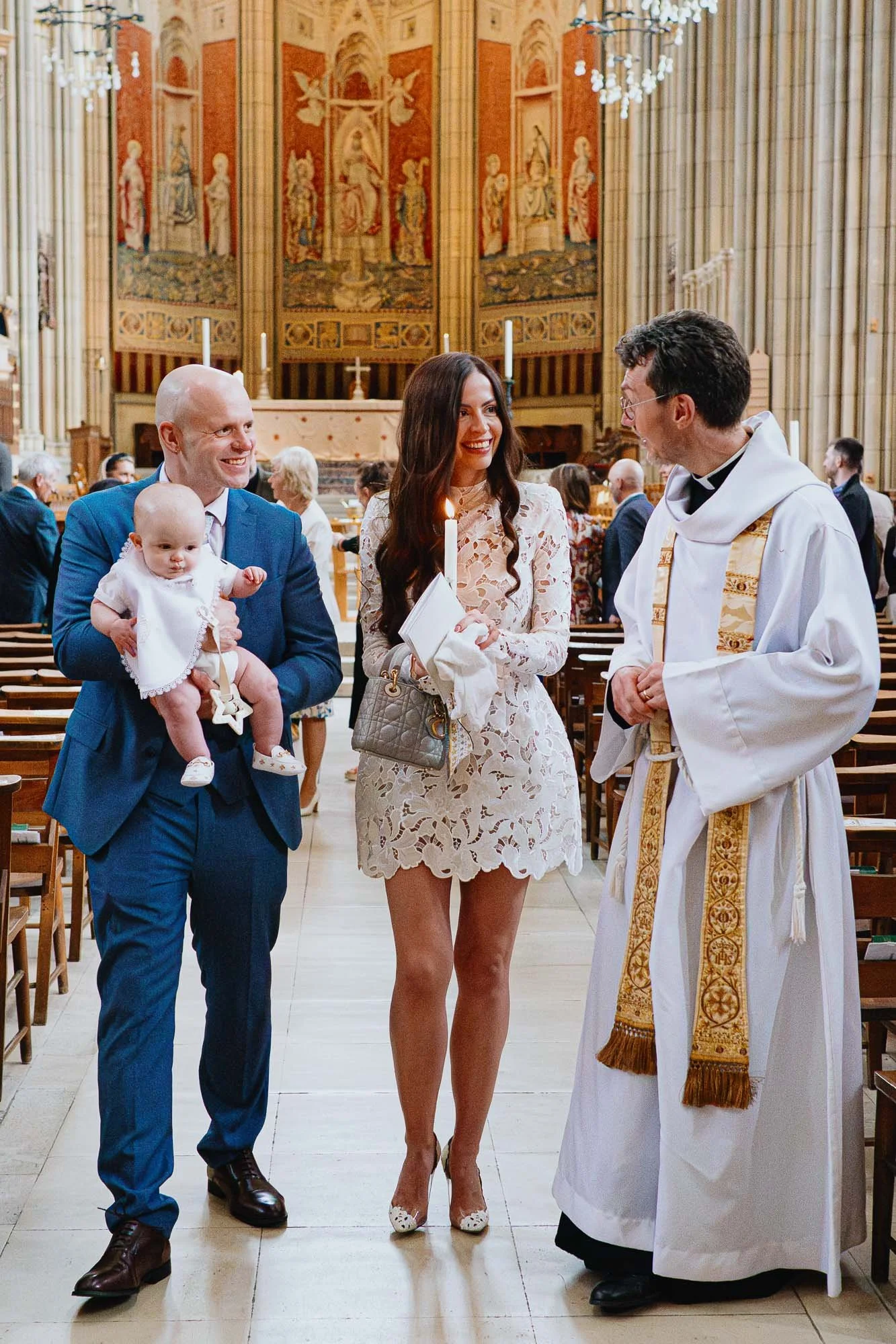 Lancing-college-christening-photographer-sussex-priest-parents-baby-boy-candle-church.jpg