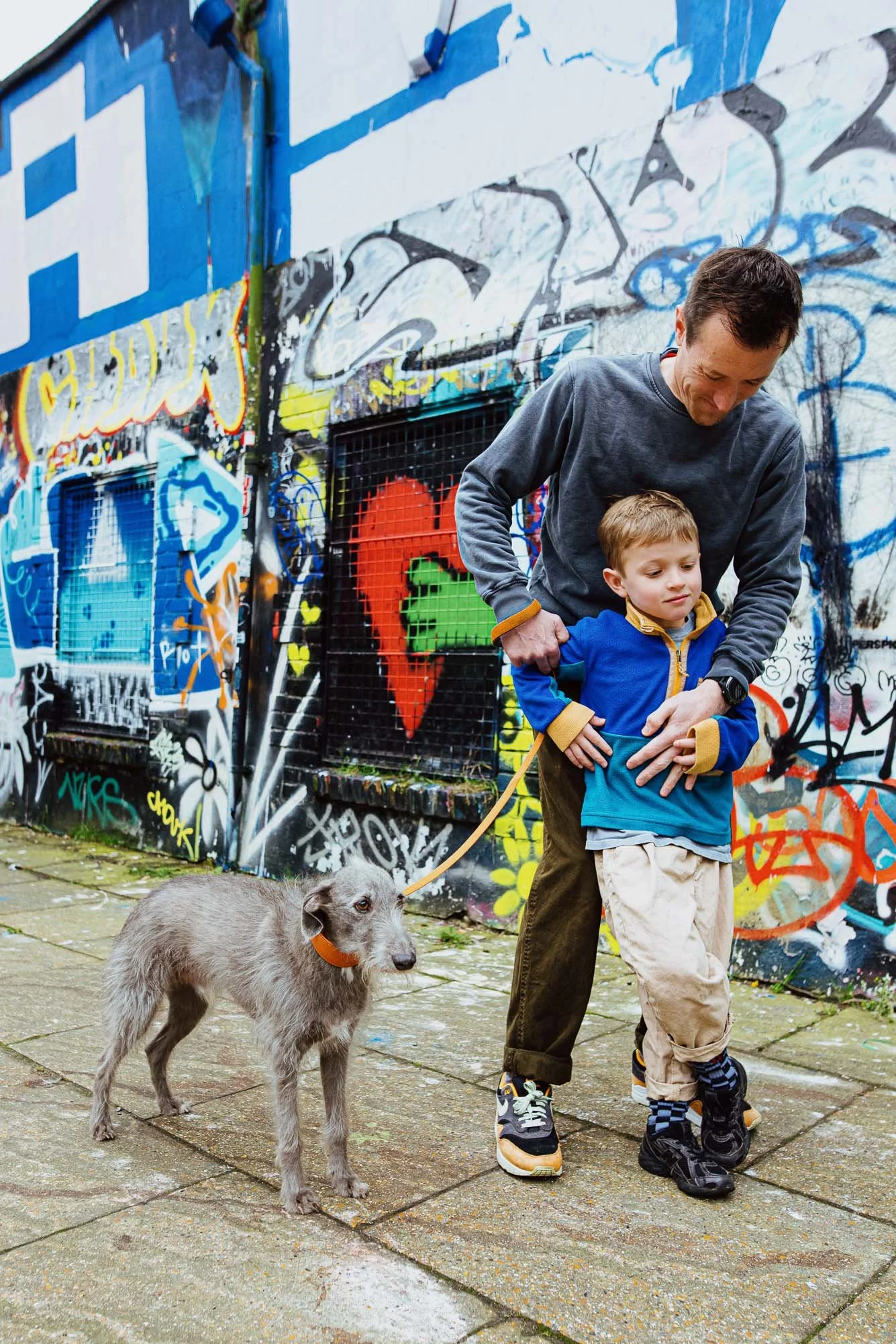 natural-portrait-dad-son-dog-brighton-the-lanes-graffiti-colourful-bold-family-photography-sussex.jpg
