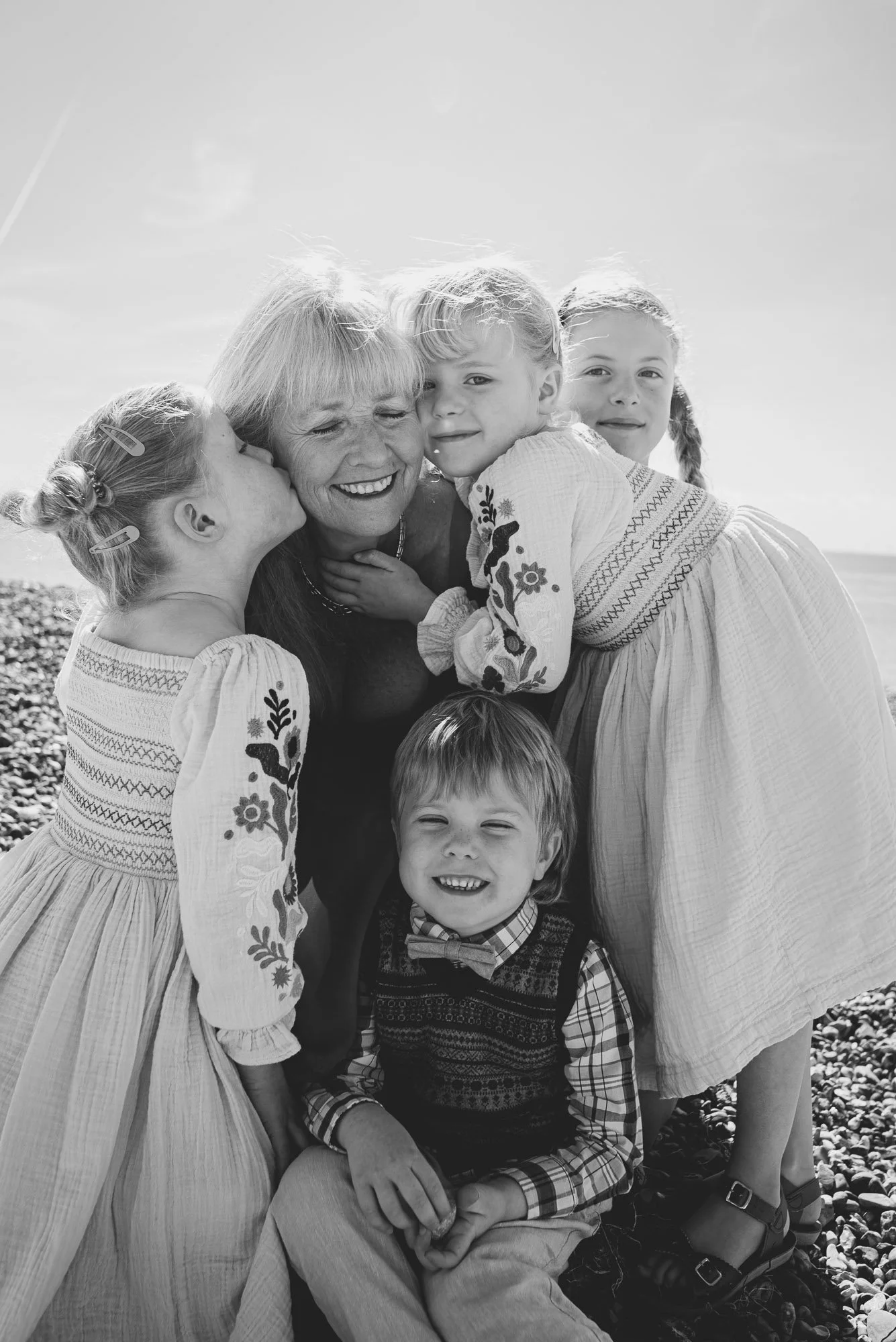Sussex family photoshoot gift voucher. Portrait of grandmother and her grand children taken at Hove beach.