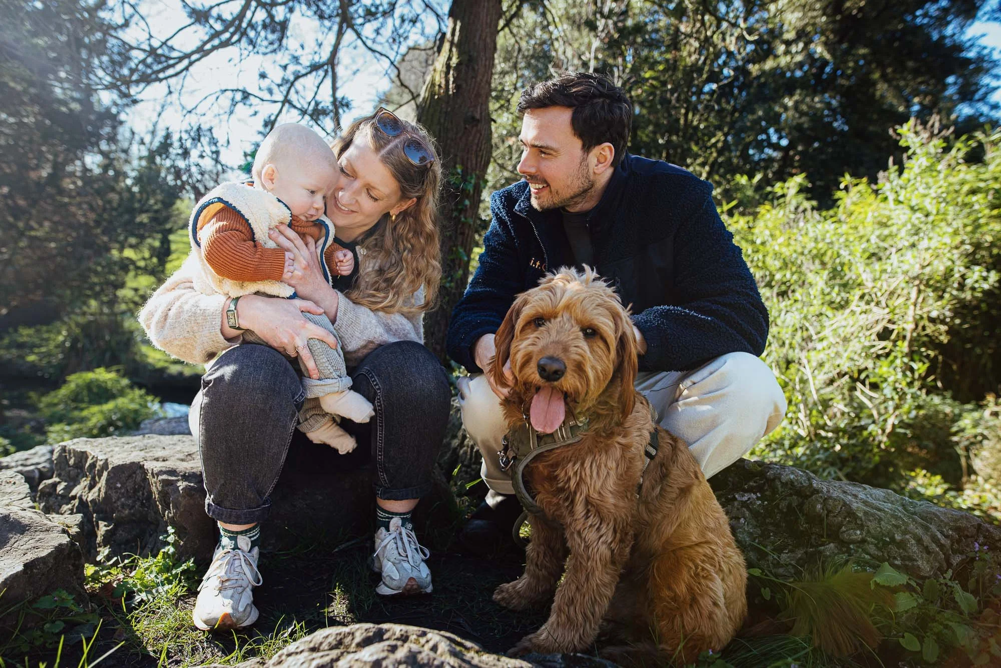 Documentary newborn photography London: portrait of parents, baby boy and dog outside in Wimbledon Park, South London.
