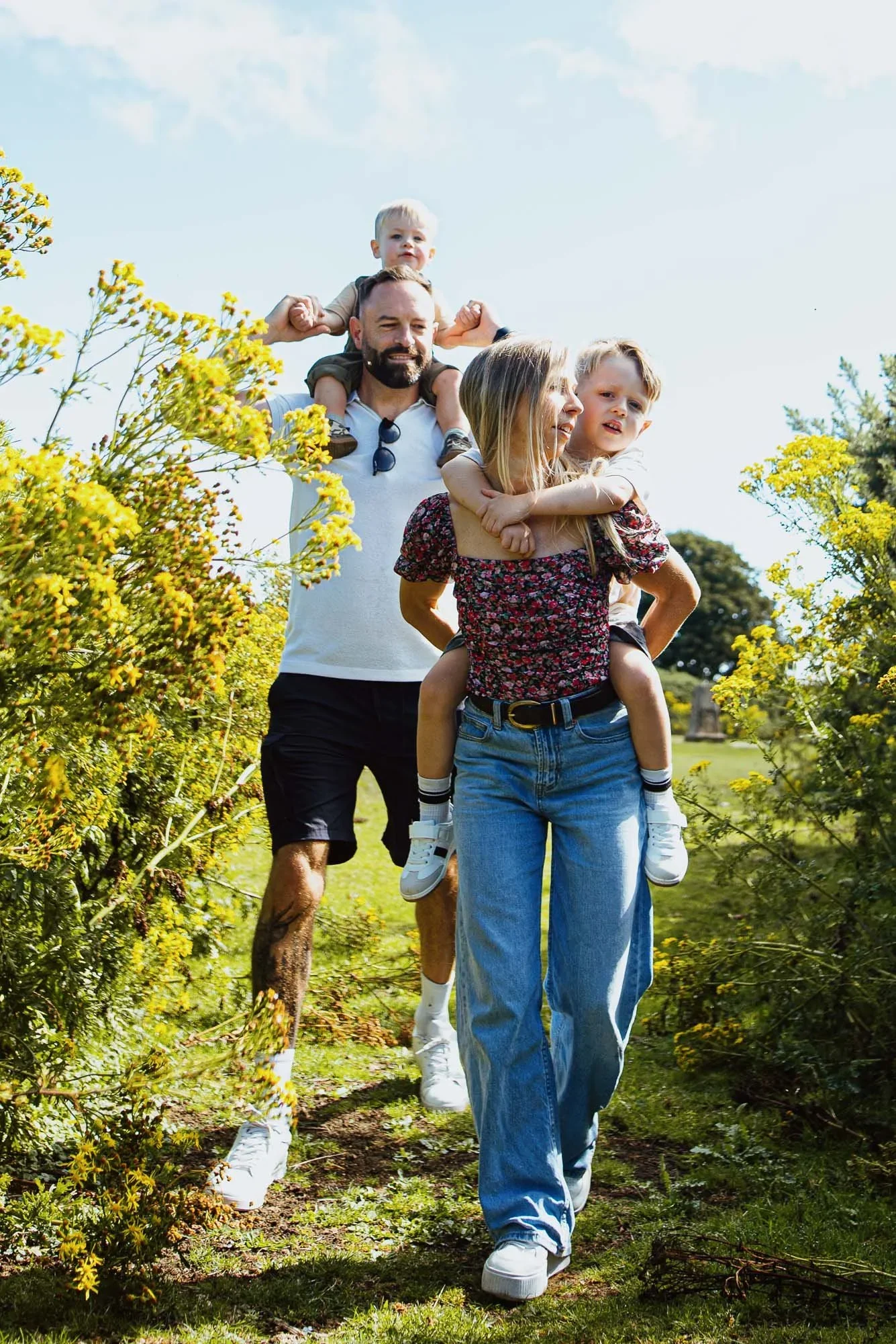smiling-parents-with-sons-during-cissbury-ring-family-photoshoot-worthing-west-sussex.webp