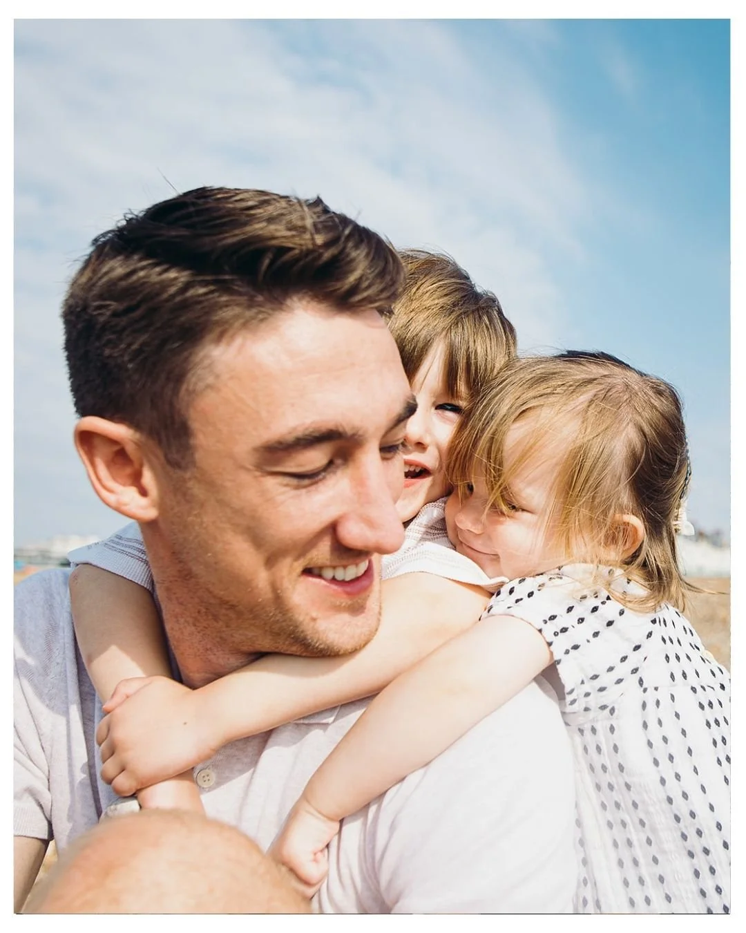 Brighton Summer family photo session at Brighton beach, dad with his two children.