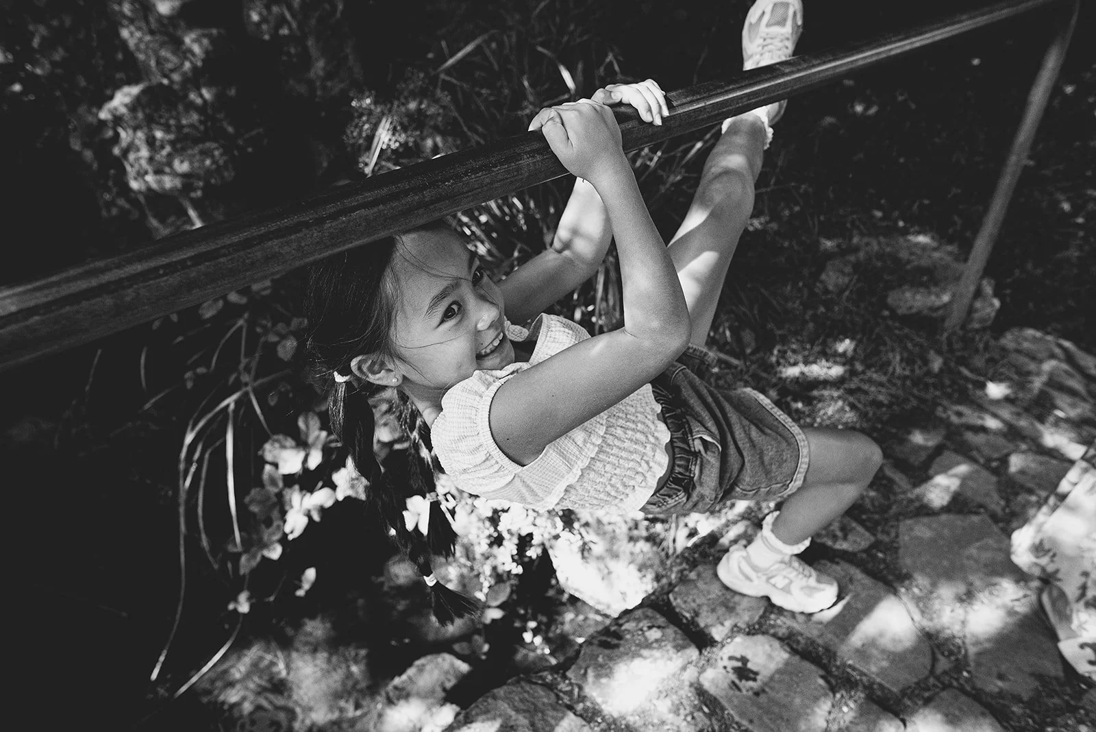 Candid family photography in Fulham Palace Gardens, portrait of a young girl playing. Award-winning family lifestyle photography in Fulham and Chelsea.