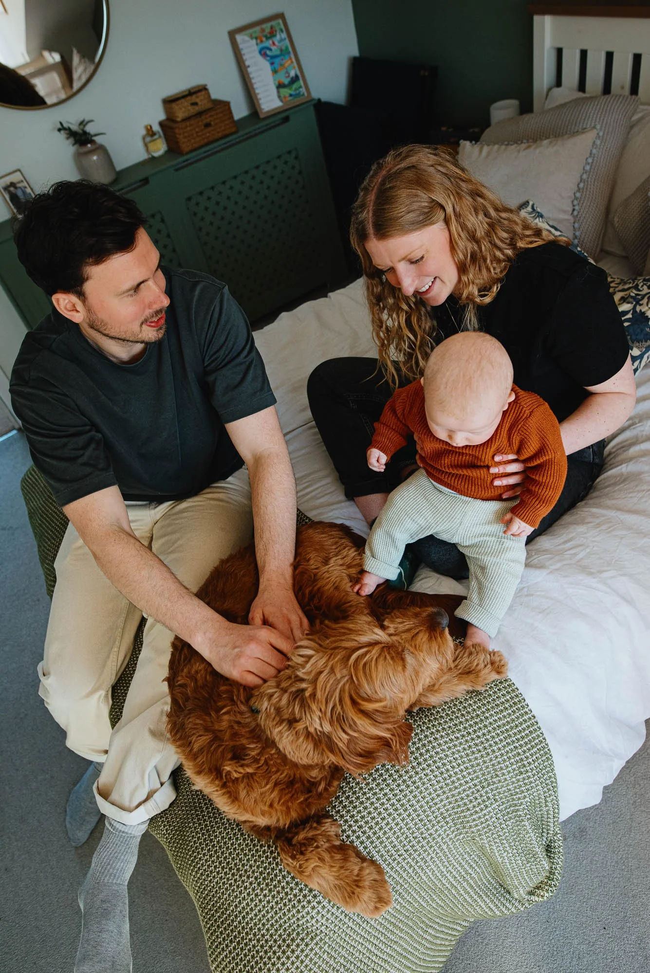 Relaxed unposed newborn photography at home in Finsbury Park and across North London. Parents, baby, dog, on their bed.
