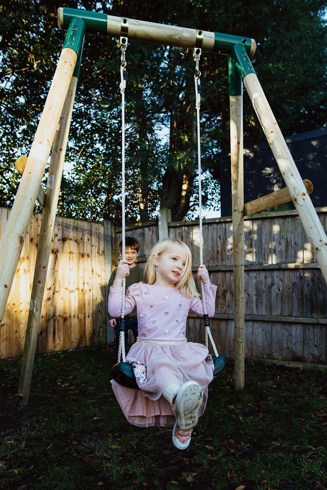 Wimbledon Village family photo session at home, portrait of siblings playing in the garden.