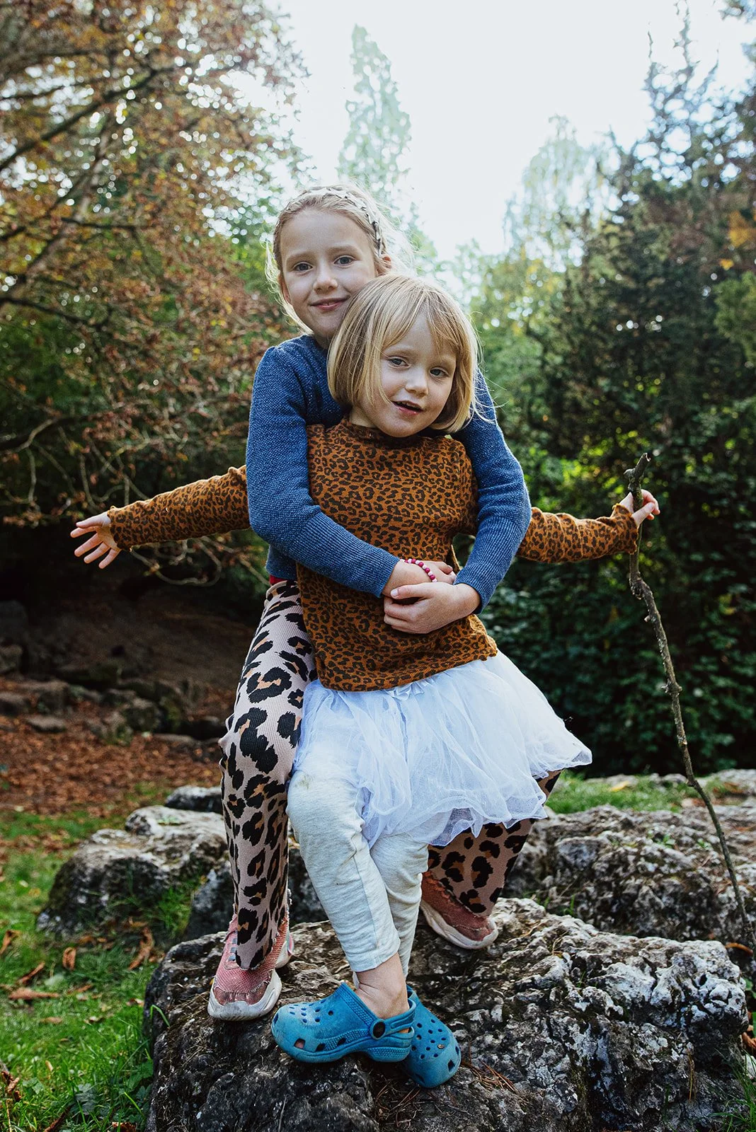 sisters-posing-reston-park-brighton-natural-lifestyle-family-photography-sussex-girls-playing-during-family-photoshoot.jpg