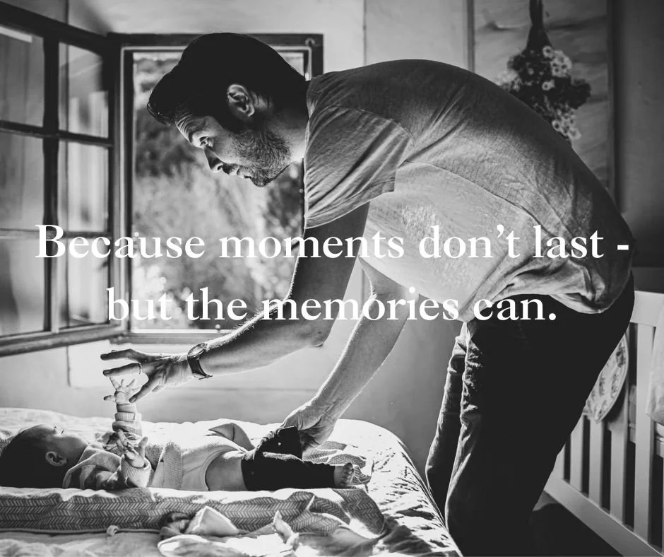 Brockley family photographer capturing dad changing daughter on the bed, window open. Black and white fine art family photography in Brockley, Dulwich, Herne Hill and across South London.