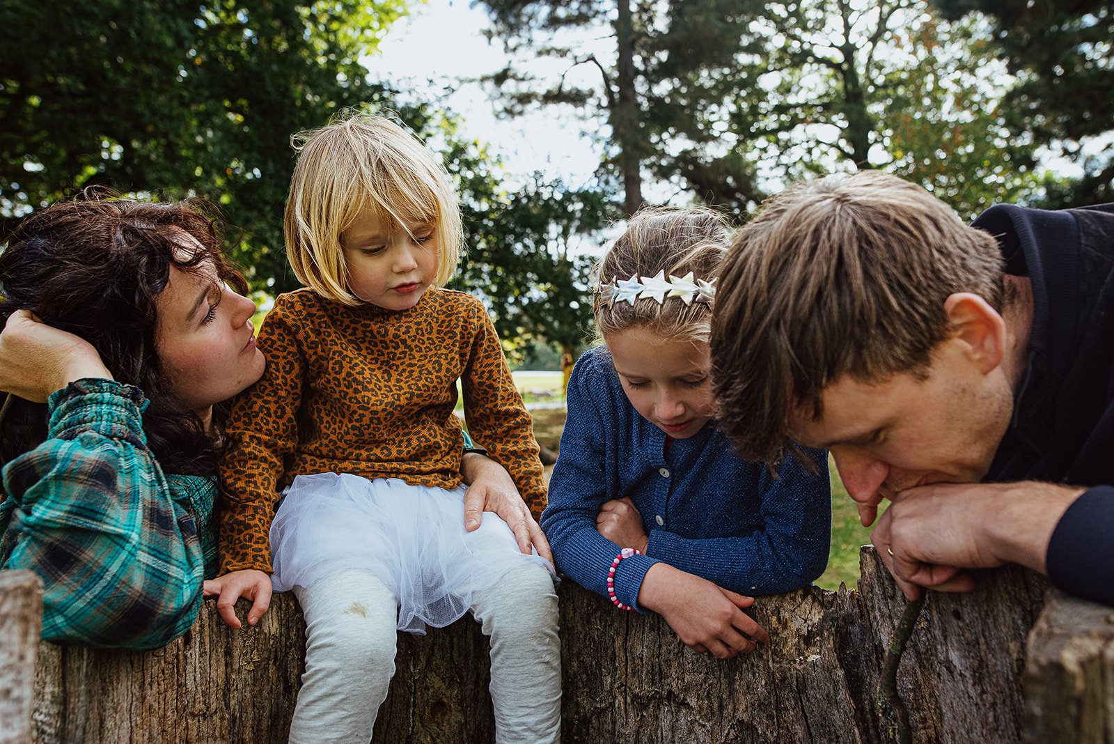 Ealing natural family photography, unposed family portrait of parents and two daughters in Lammas Park in Ealing.