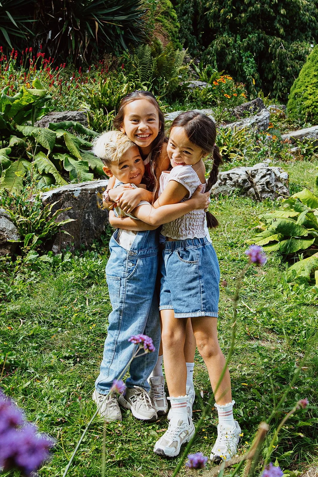 Brighton_Hove_Award_Winning_Family_photography_portrait_three_siblings_hugging_rock_gardens_preston_park.jpg