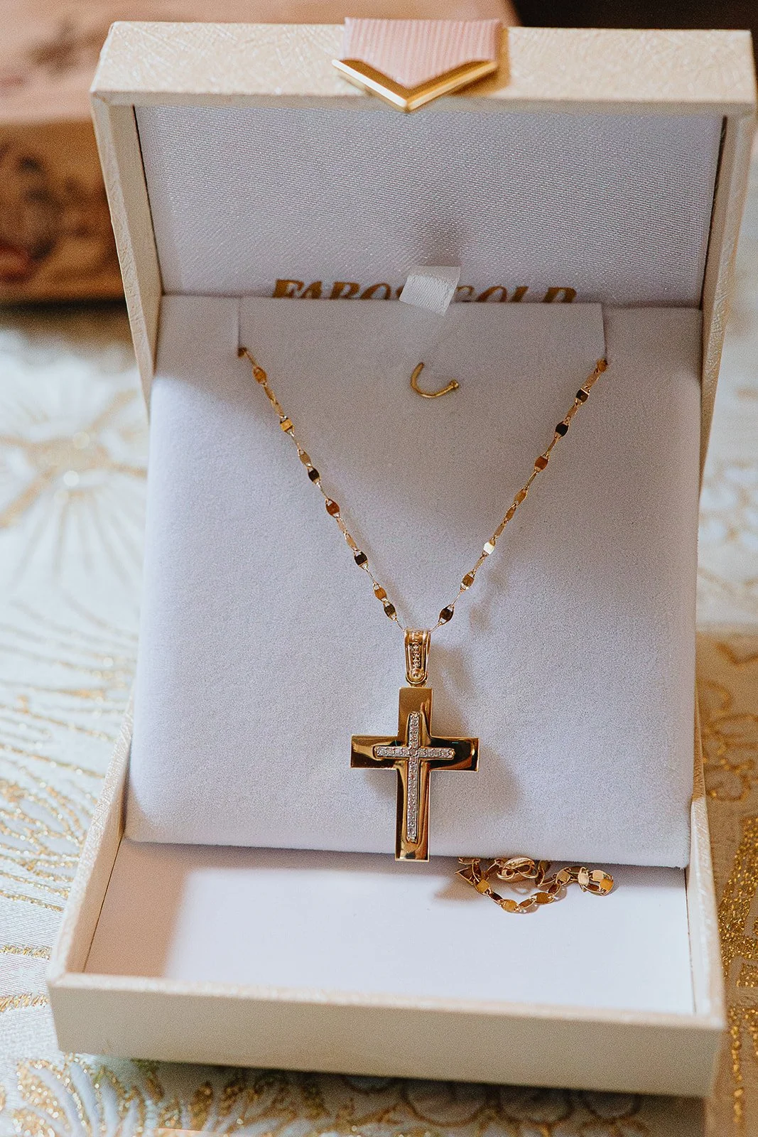baptism-photographer-clapham-south-london-documentary-style-close-up-cross-necklace-christening-ceremony.jpg