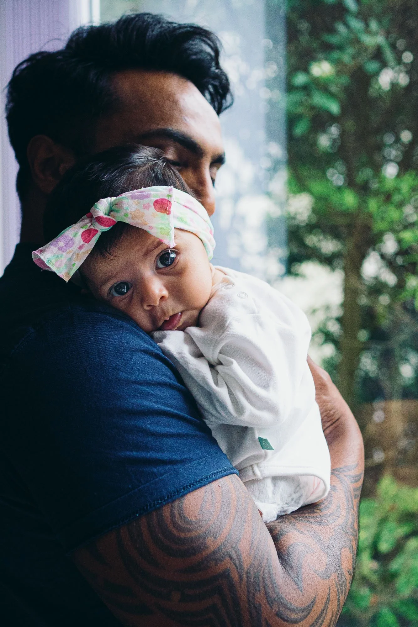 Dad and baby girl, natural newborn portrait at home in house in Greenwich, South London.
