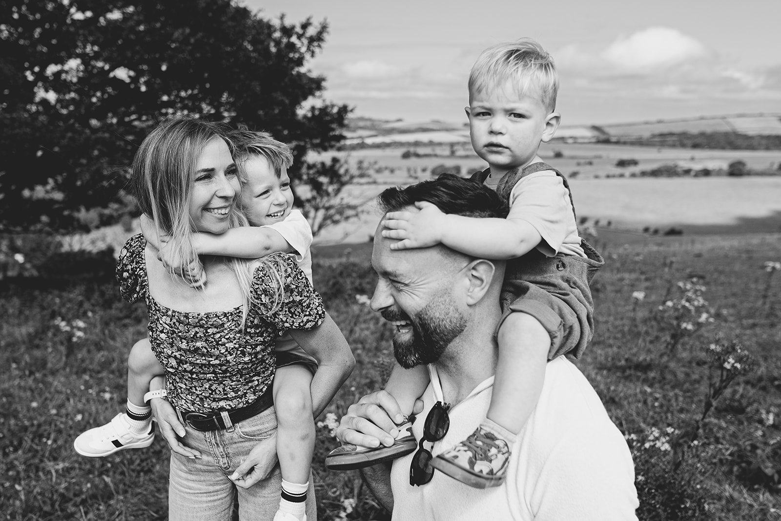 Sussex candid family photography, portrait of parents and their sons taken during a walk in the South Downs, West Sussex.