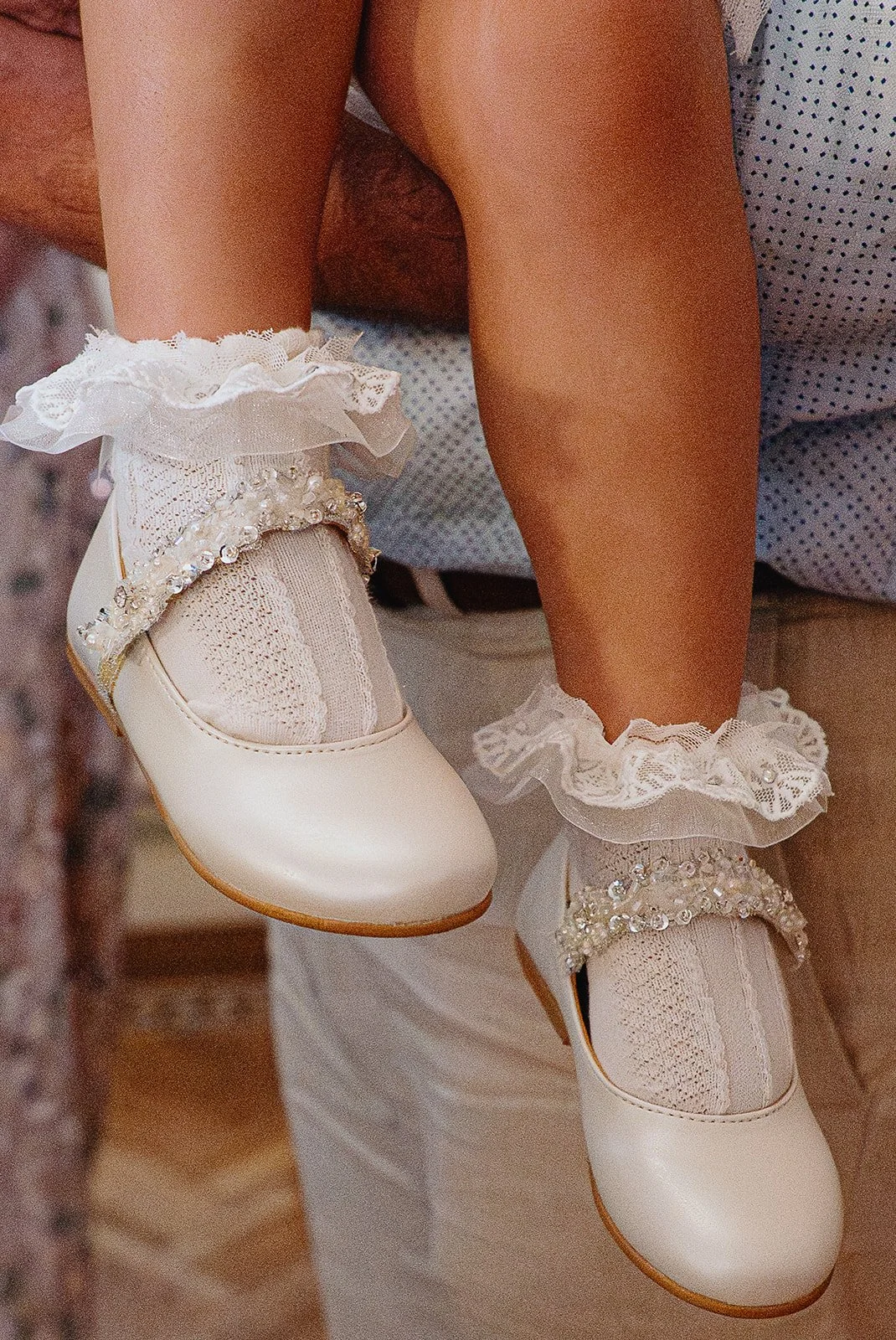 Sloane Square christening photography, documentary style, closeup shot of Christening shoes girl.