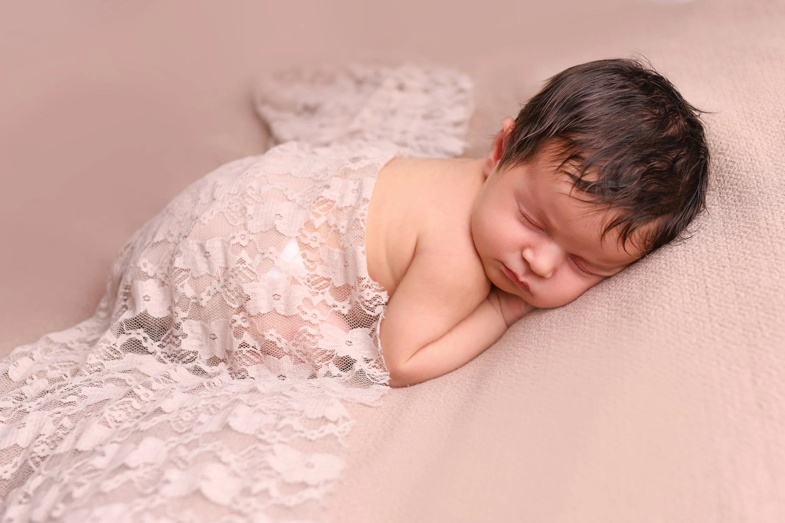 Sleeping baby with lots of hair. 