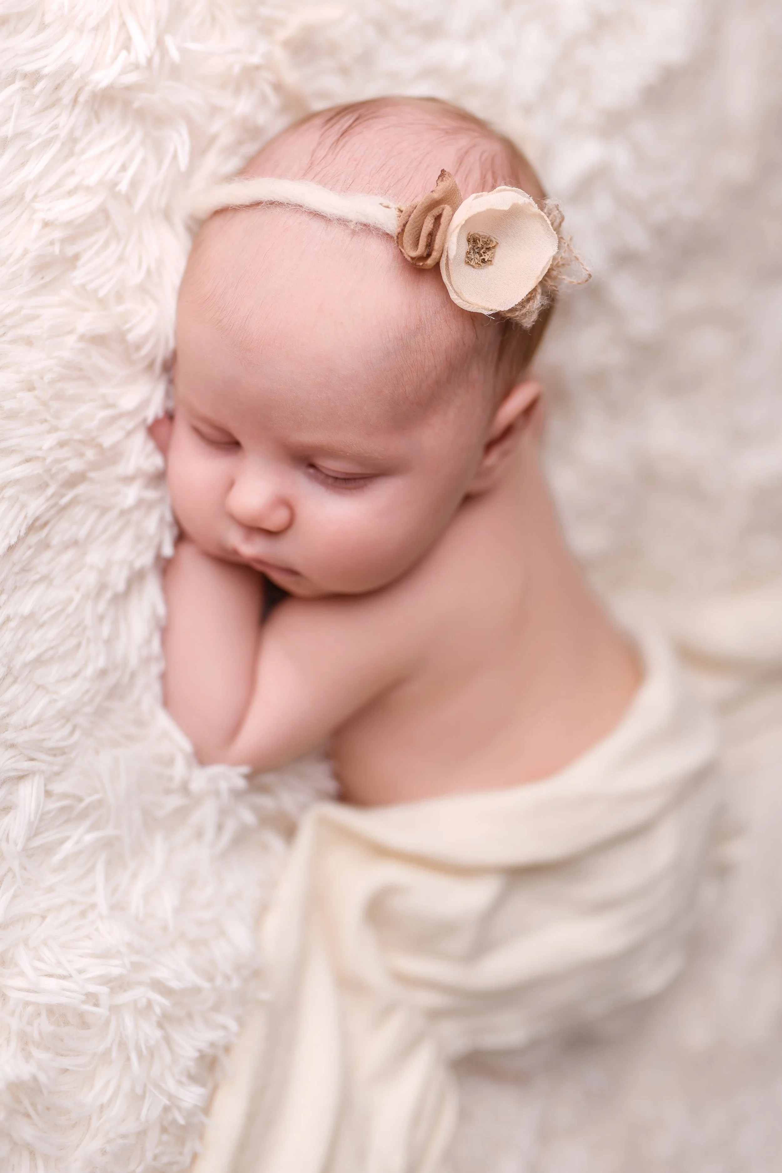 sleeping newborn in a headband