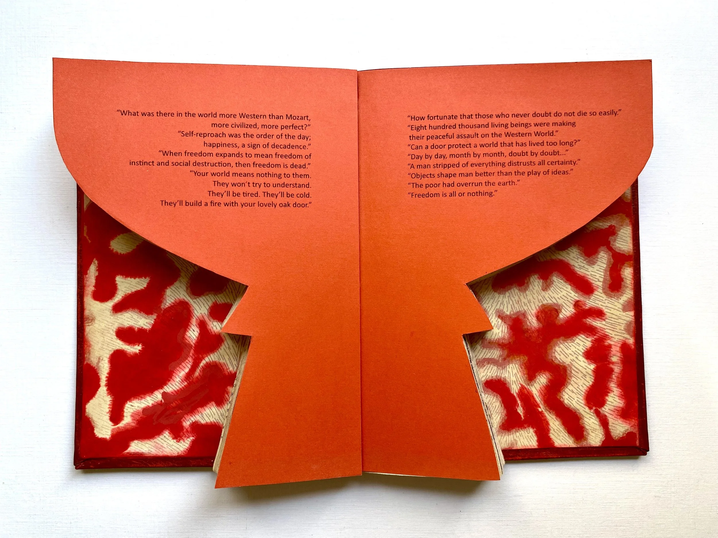 Bookscape – Censored – The Camp of the Saints, 2026. Handcrafted and cut book, marbled paper, acrylic paint, and wood.
24 × 30 cm.
