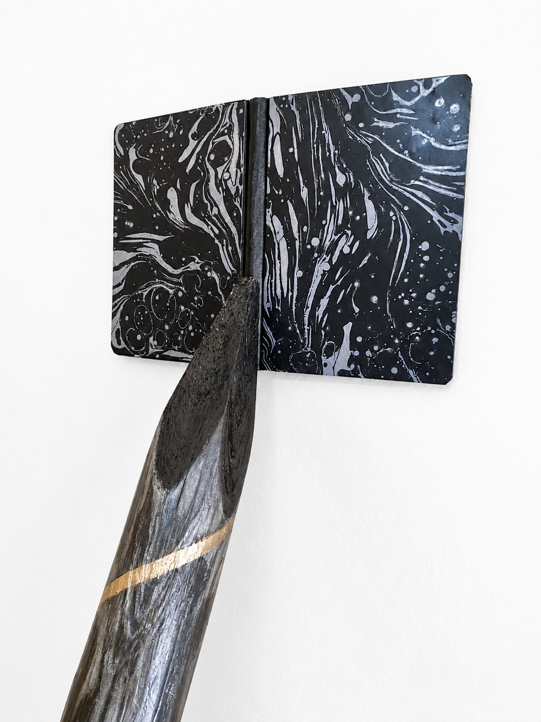 PENCIL WITH NOTEBOOK ( detail)  2026
found wood branch, graphite, gold leaf, marbling paper/ notebook, silver ink, 180 high x 45 x 35 cm
