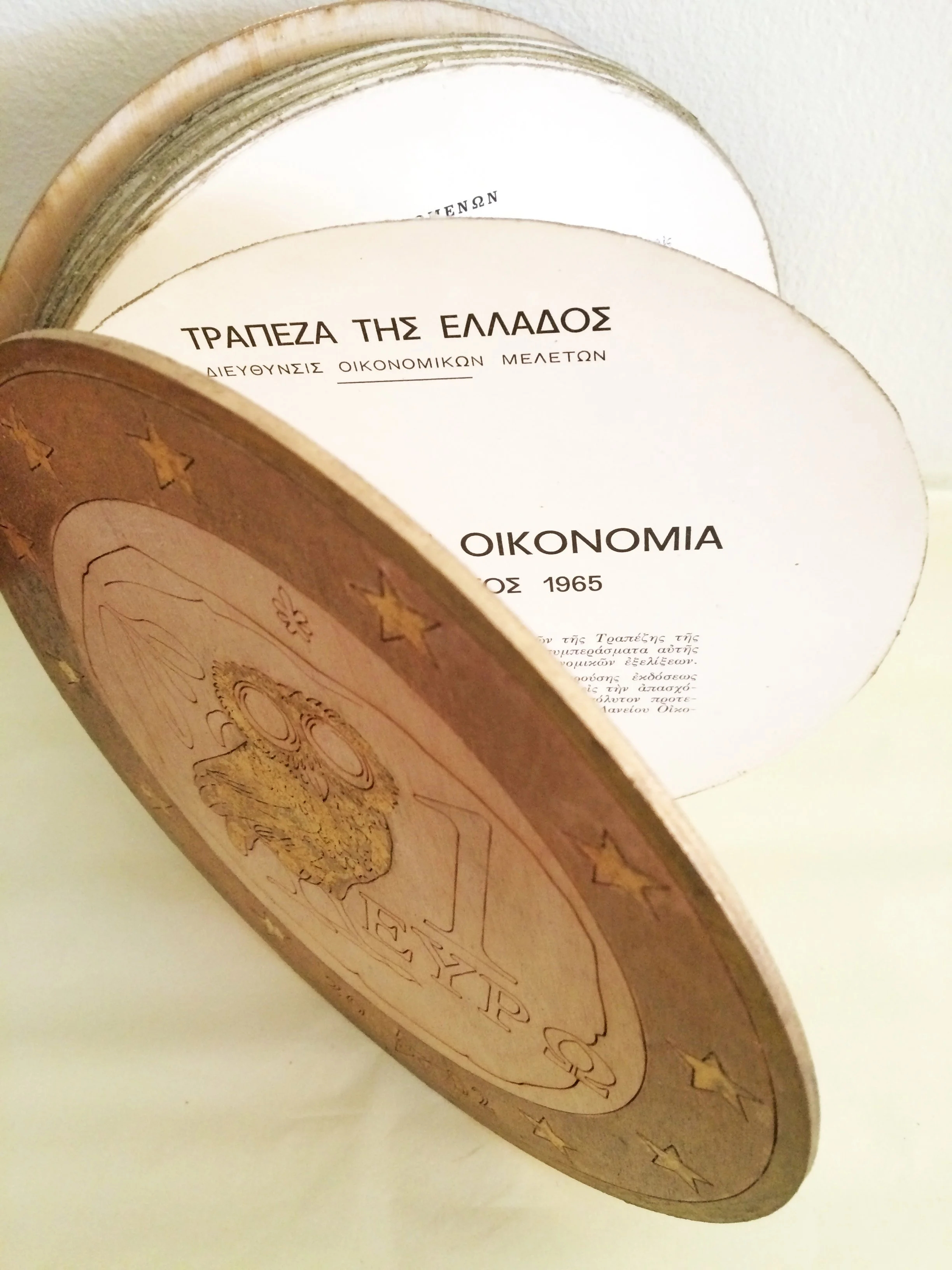 Euro-Volvelle , 2019 Altered vintage book, wood, laser-cut cover, gold leaf, 10 cm high x 40 cm diam.