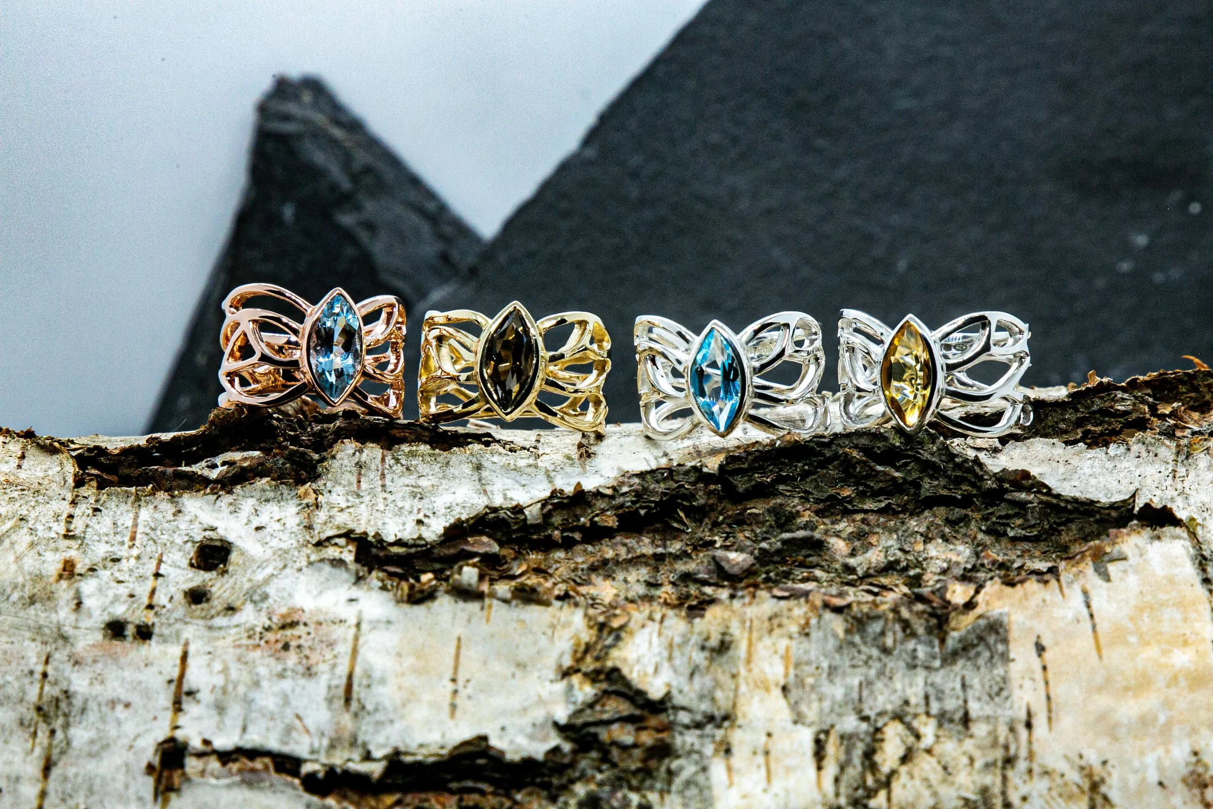 A collection of J.T.R.Jewellery Butterfly rings, showing off 9ct Rose gold, 9ct Yellow Gold and sterling silver with topaz, smokey quarts, citrine and aquamarine