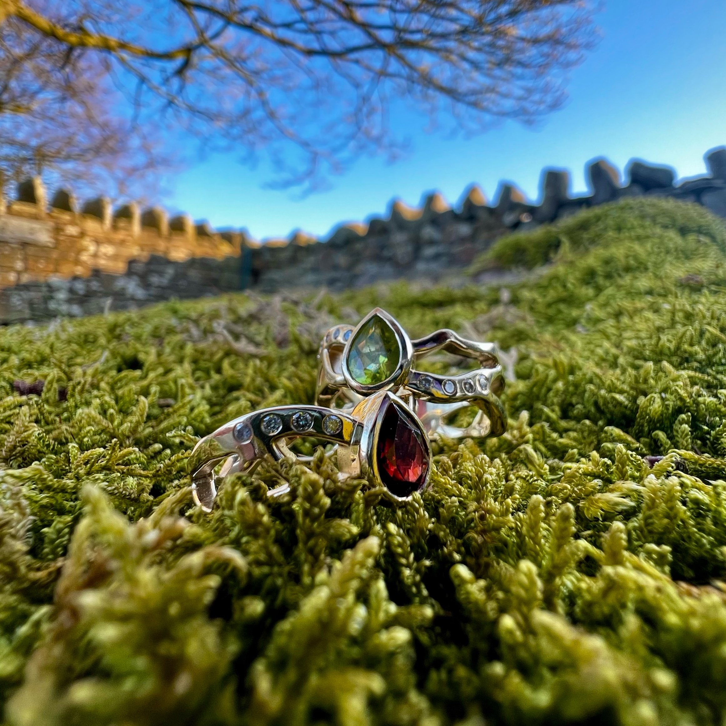 Bespoke pair of rings using the clients stones from her engagement ring and matching pendant