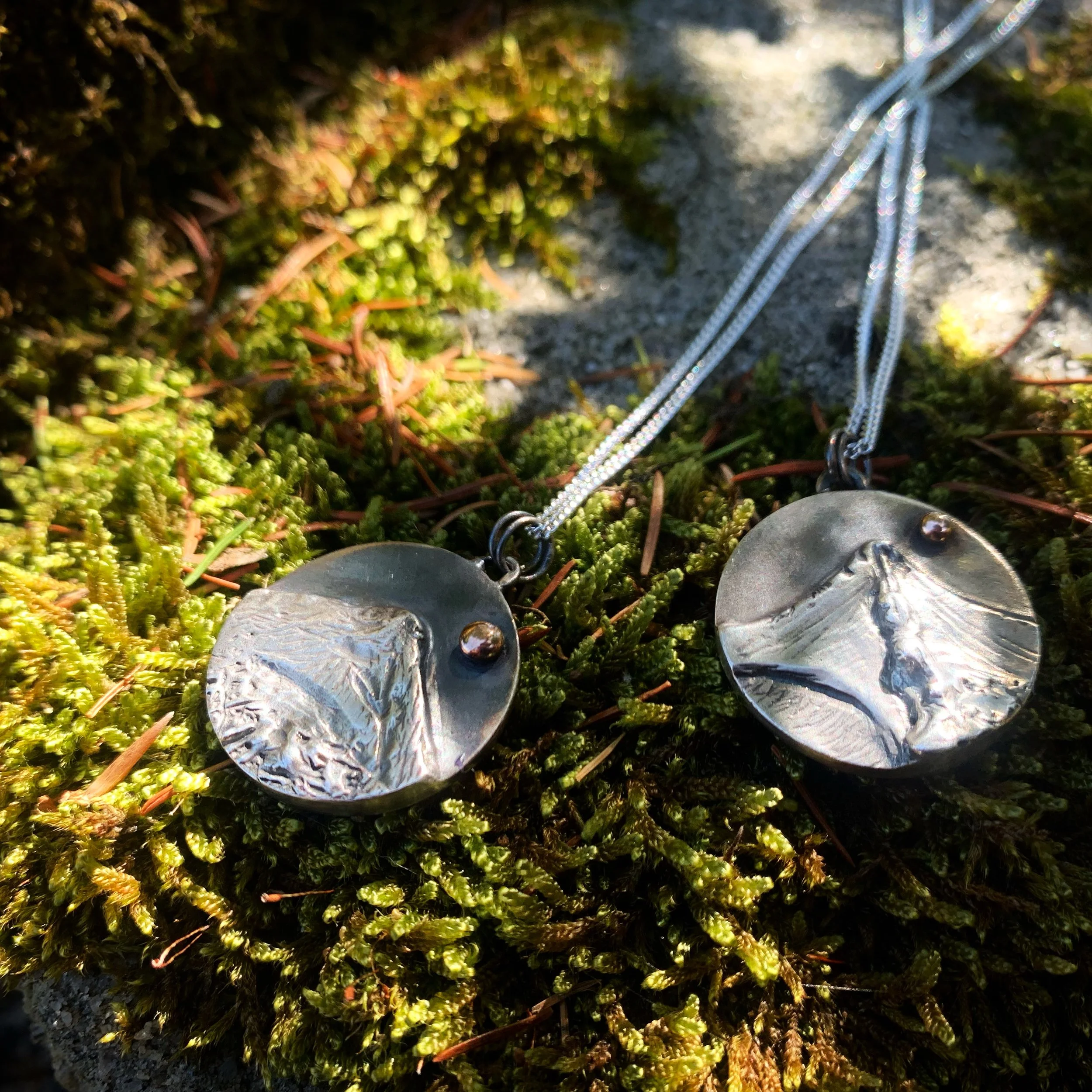 The Lake District Fells pendant range, showing Rannerdale Knotts and Striding Edge in sterling silver