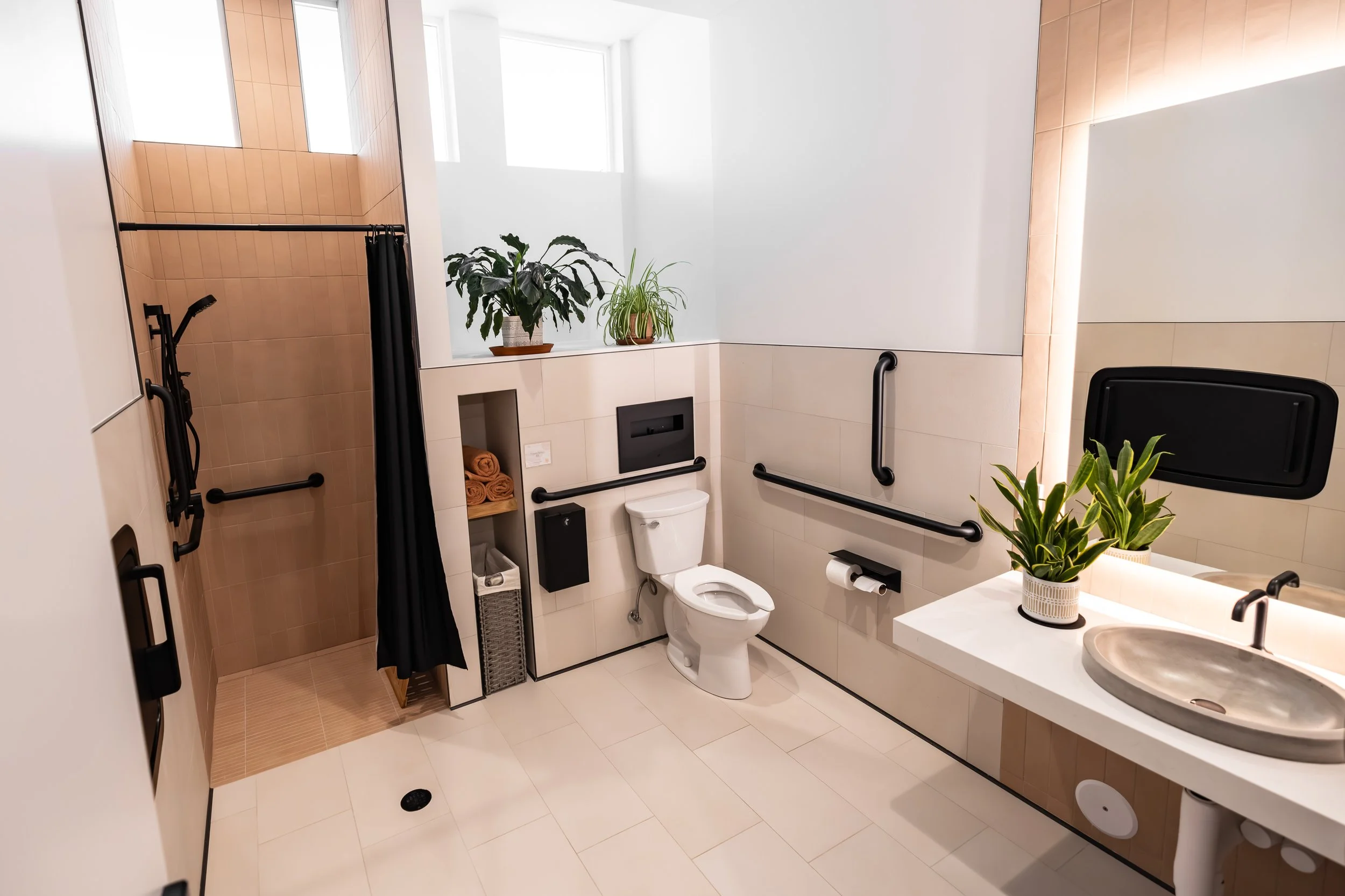 Bathroom with ADA shower, toilet and sink