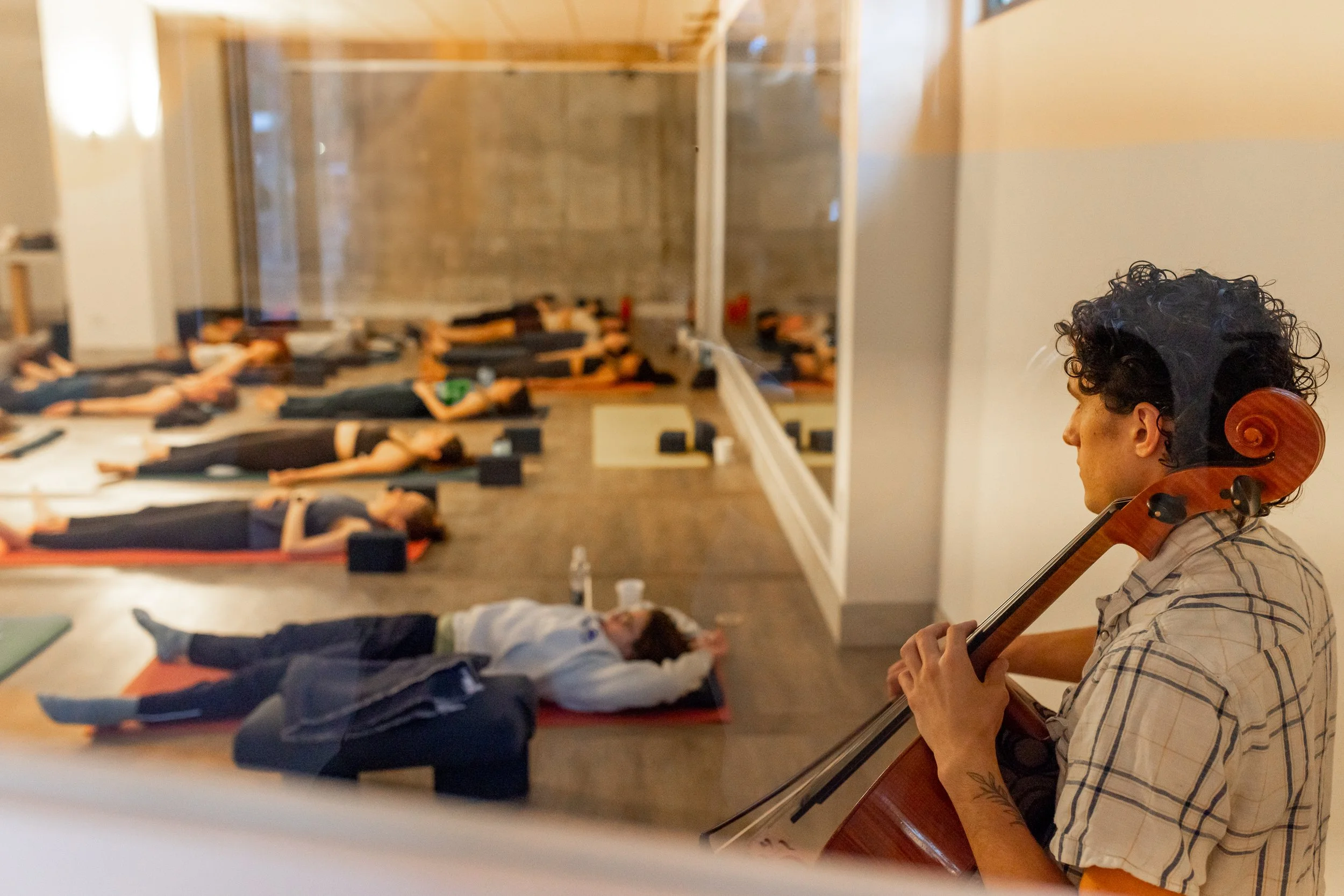 Cellist playing for a yoga class