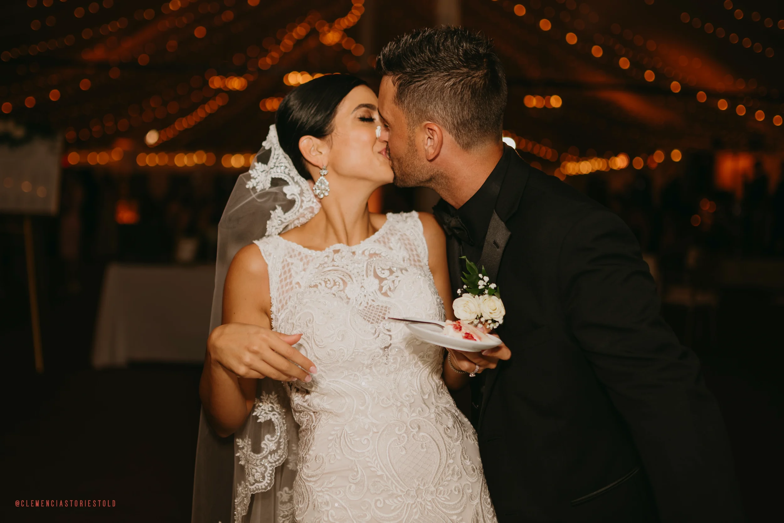 Bride and groom kissing at their wedding reception